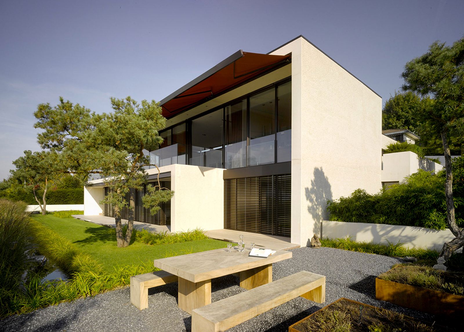 Garden side with timber bench and pines