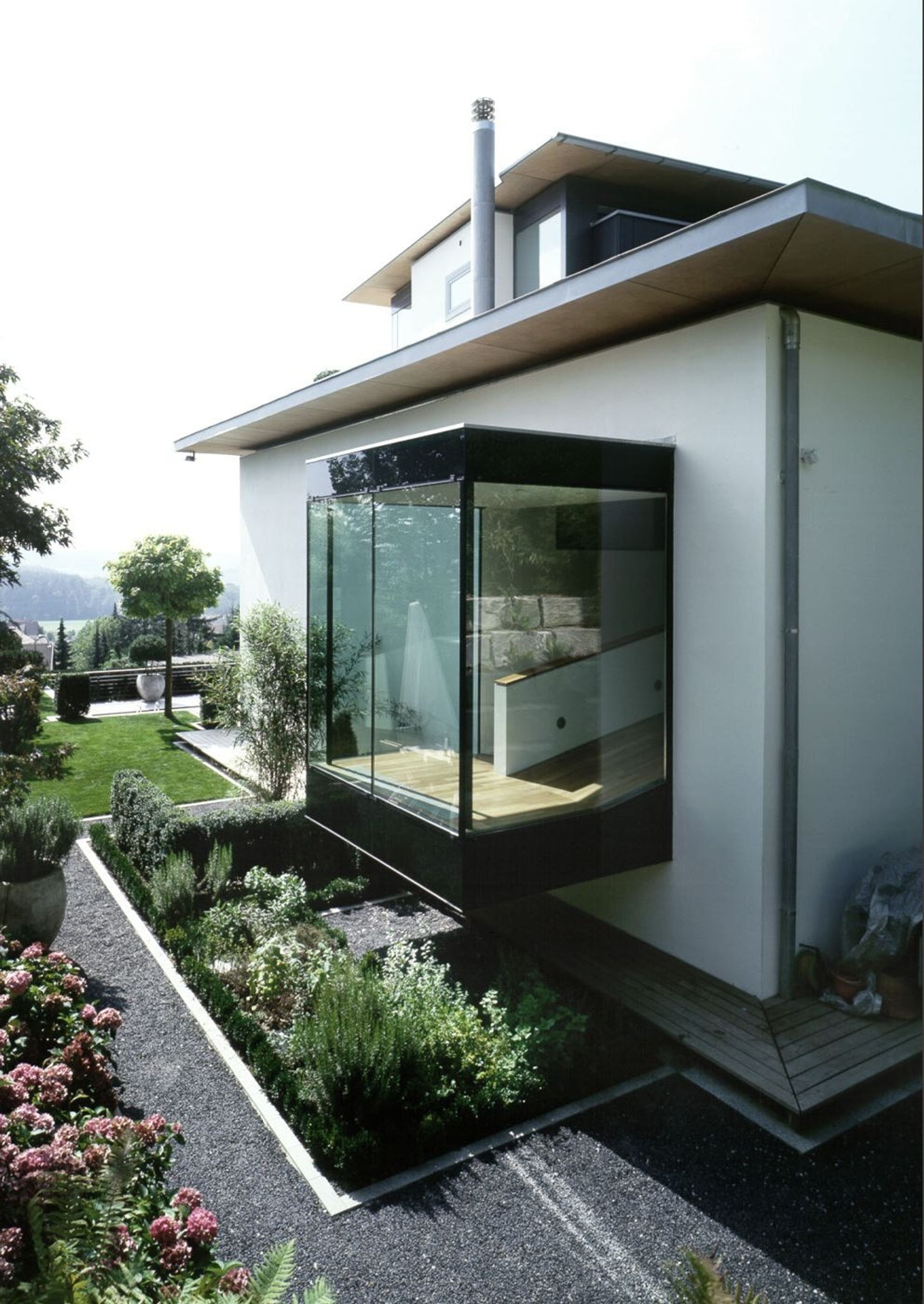 Glass extension with planting – Single-family house