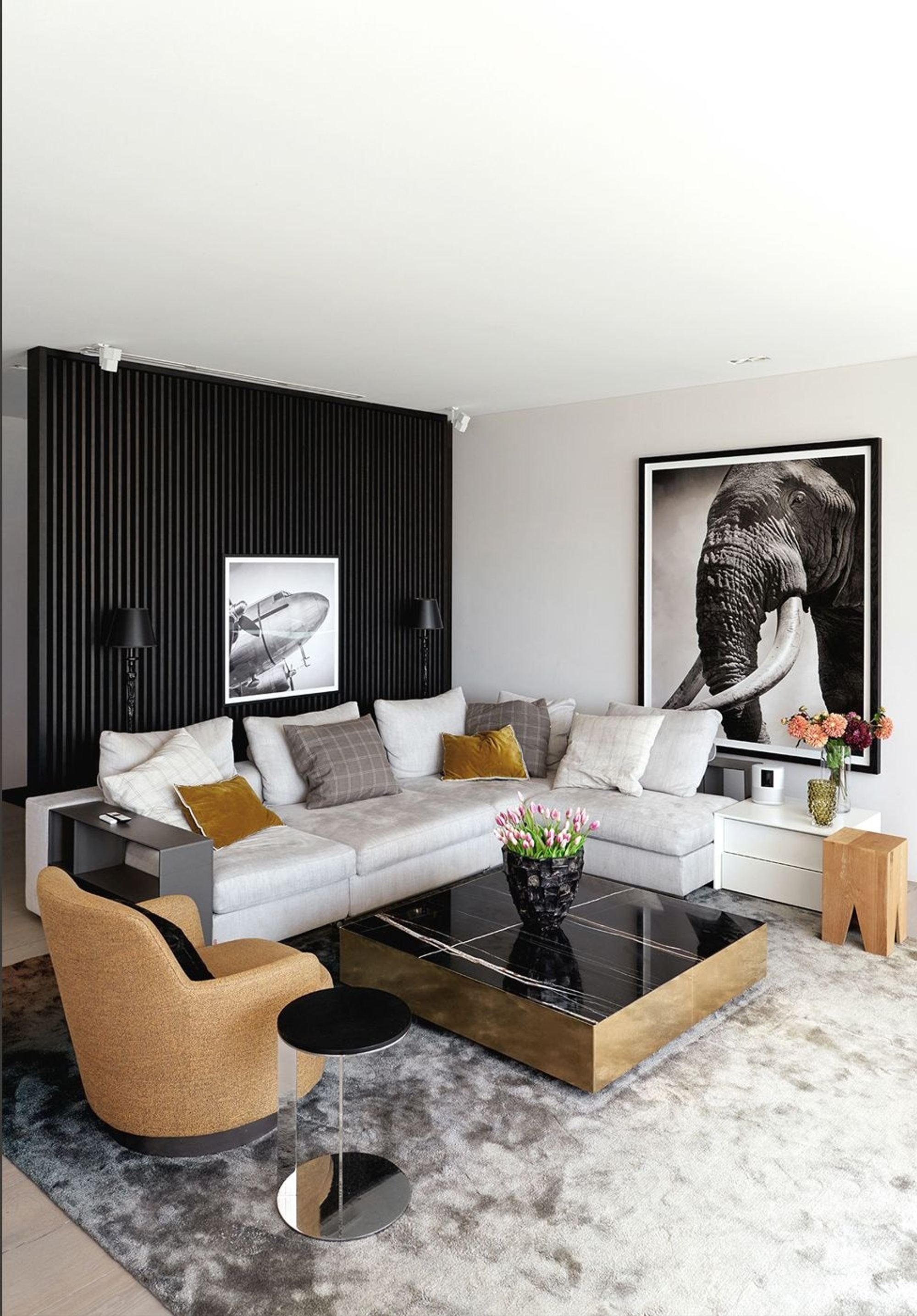 Seating area against a dark wall with photograph – Interiors and landscape, Luzern