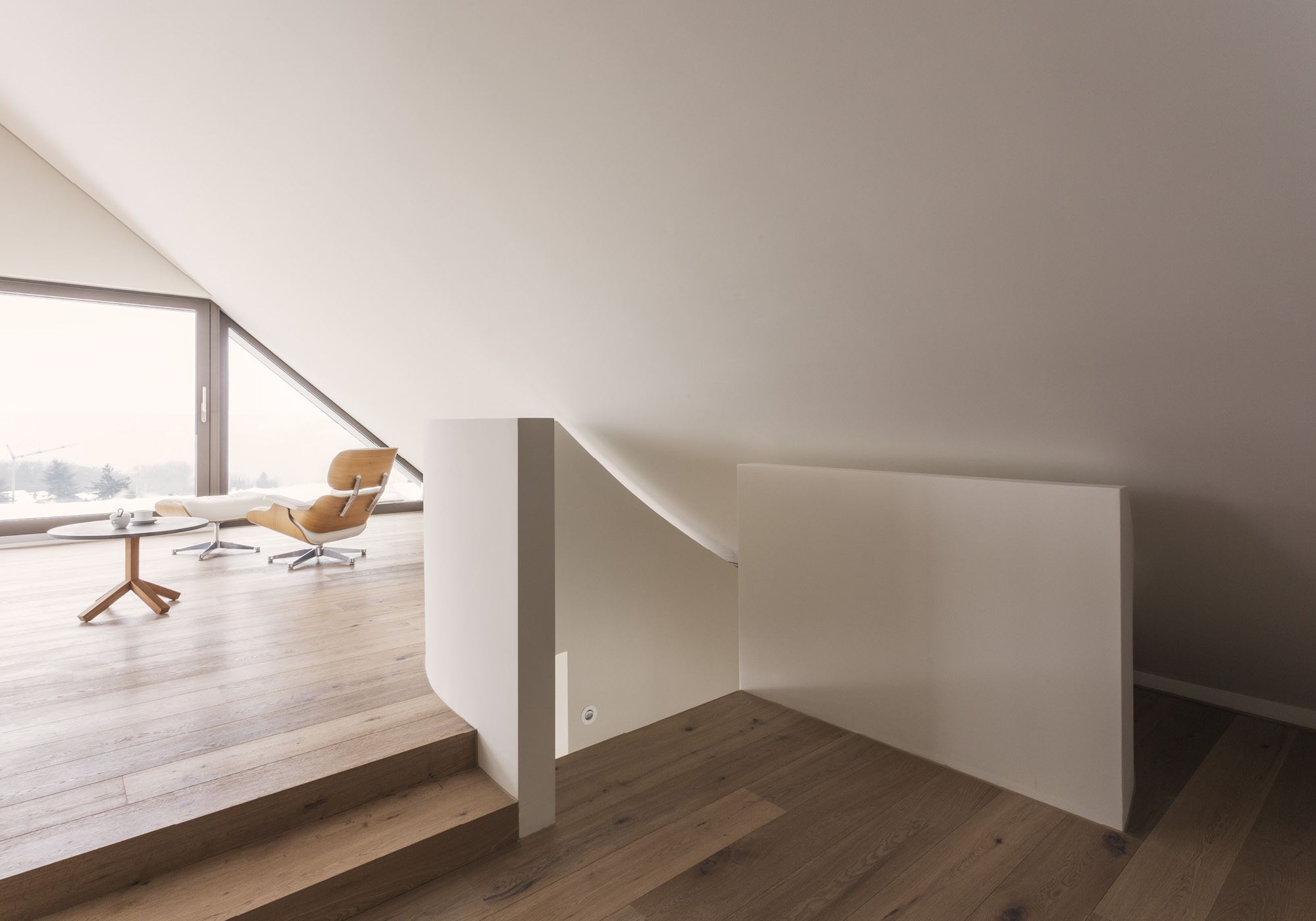 Attic floor with gallery and lounge chair – Interiors and landscape, Herrliberg