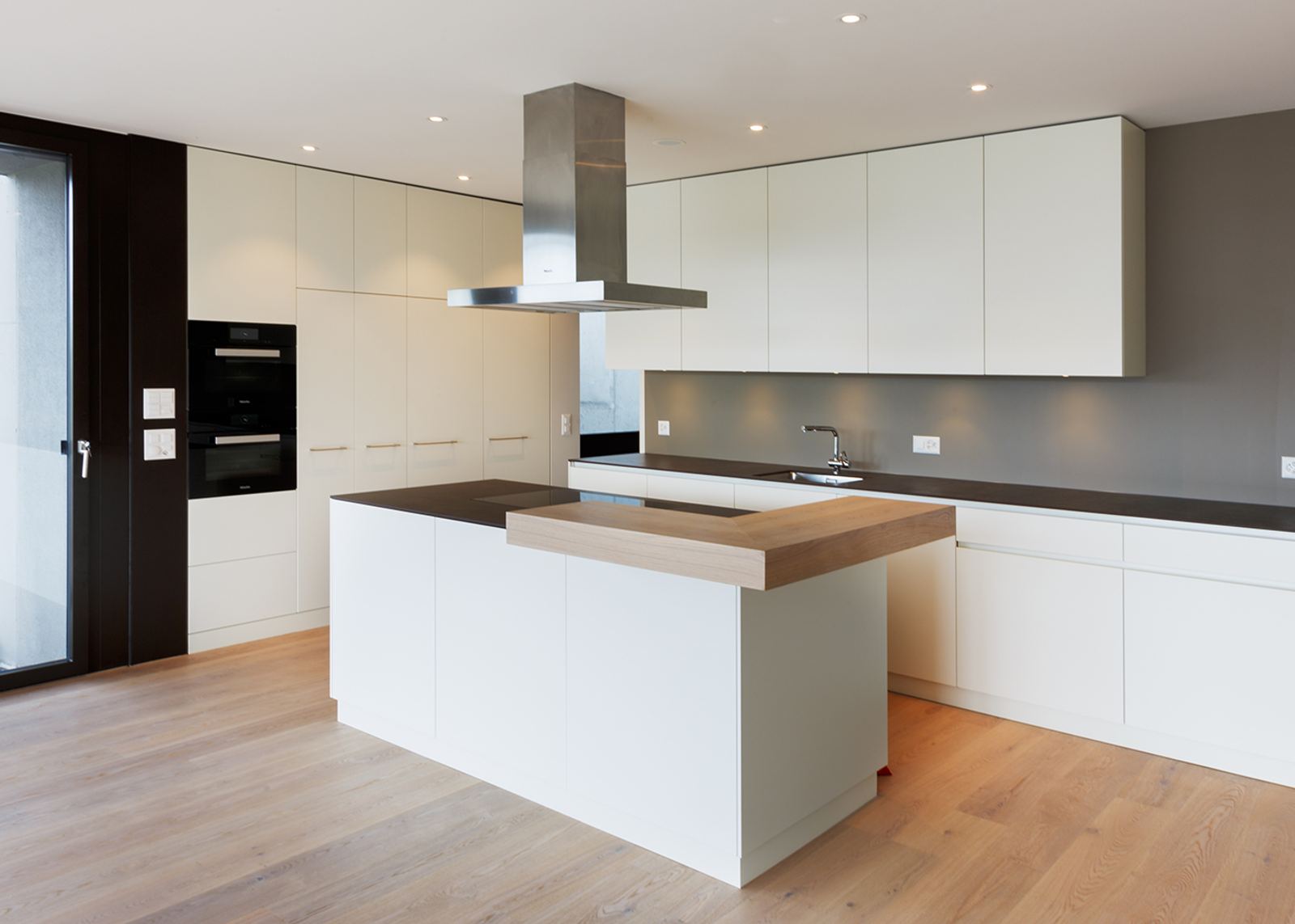 White kitchen with timber shelf on the island