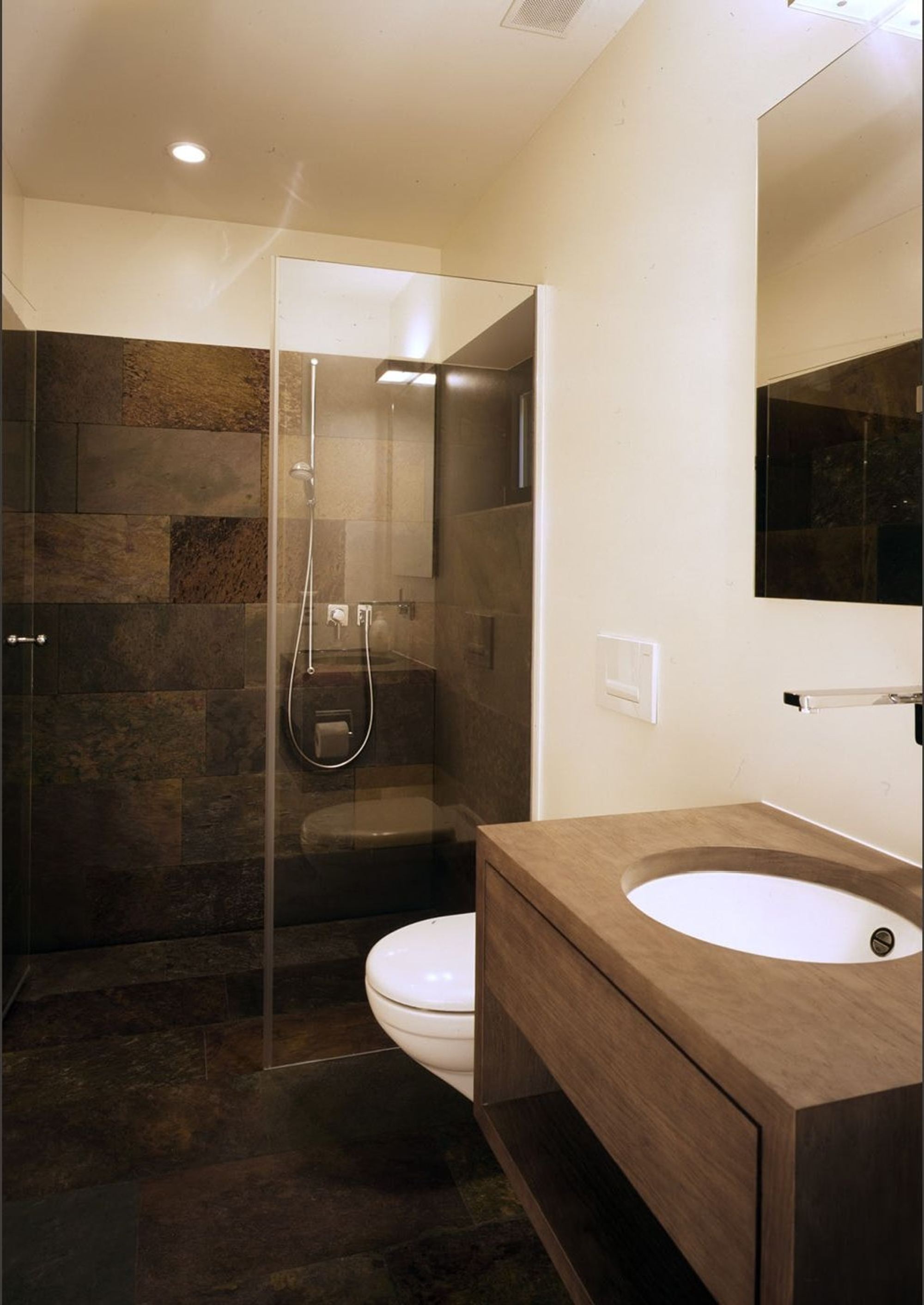 Bathroom with timber vanity and glass shower – Single-family house in Bonstetten
