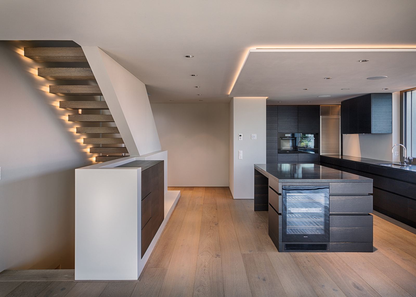 Illuminated staircase above the kitchen