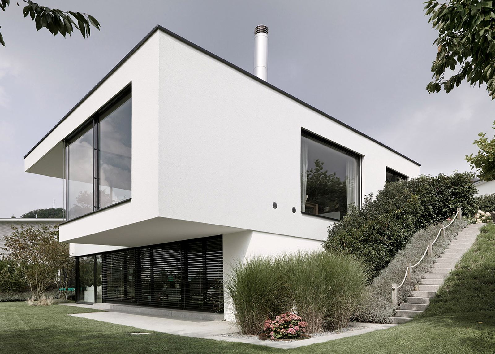 White house with grasses on the slope