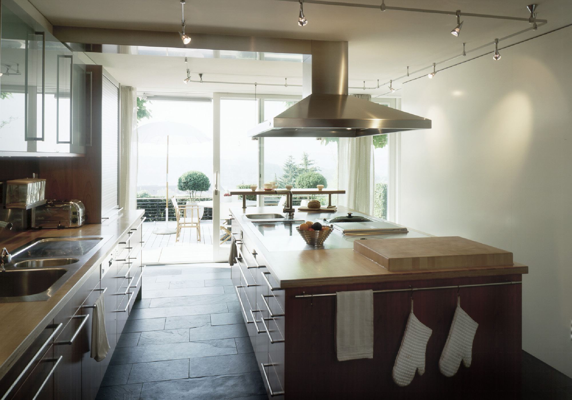 Kitchen with stainless steel hood and timber island – Single-family house