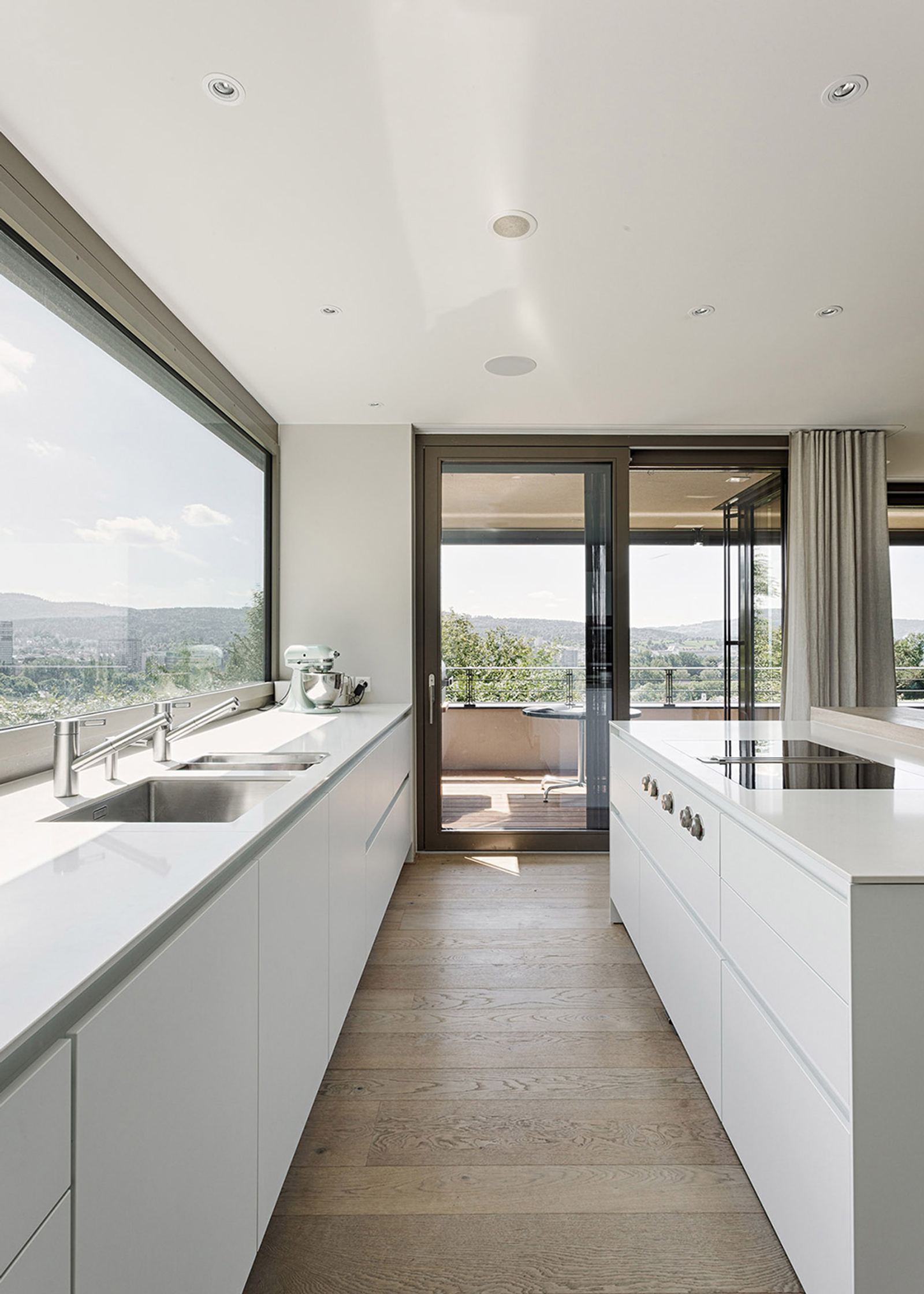 Narrow white kitchen with ribbon window