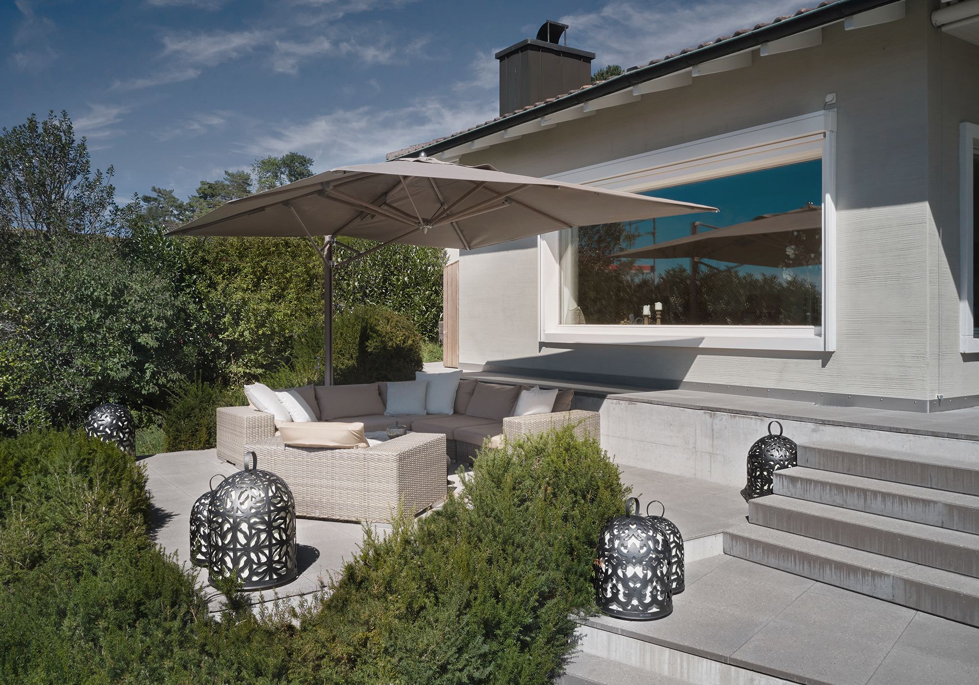 Seating area with parasol in front of the house – Interiors and landscape, Lufingen