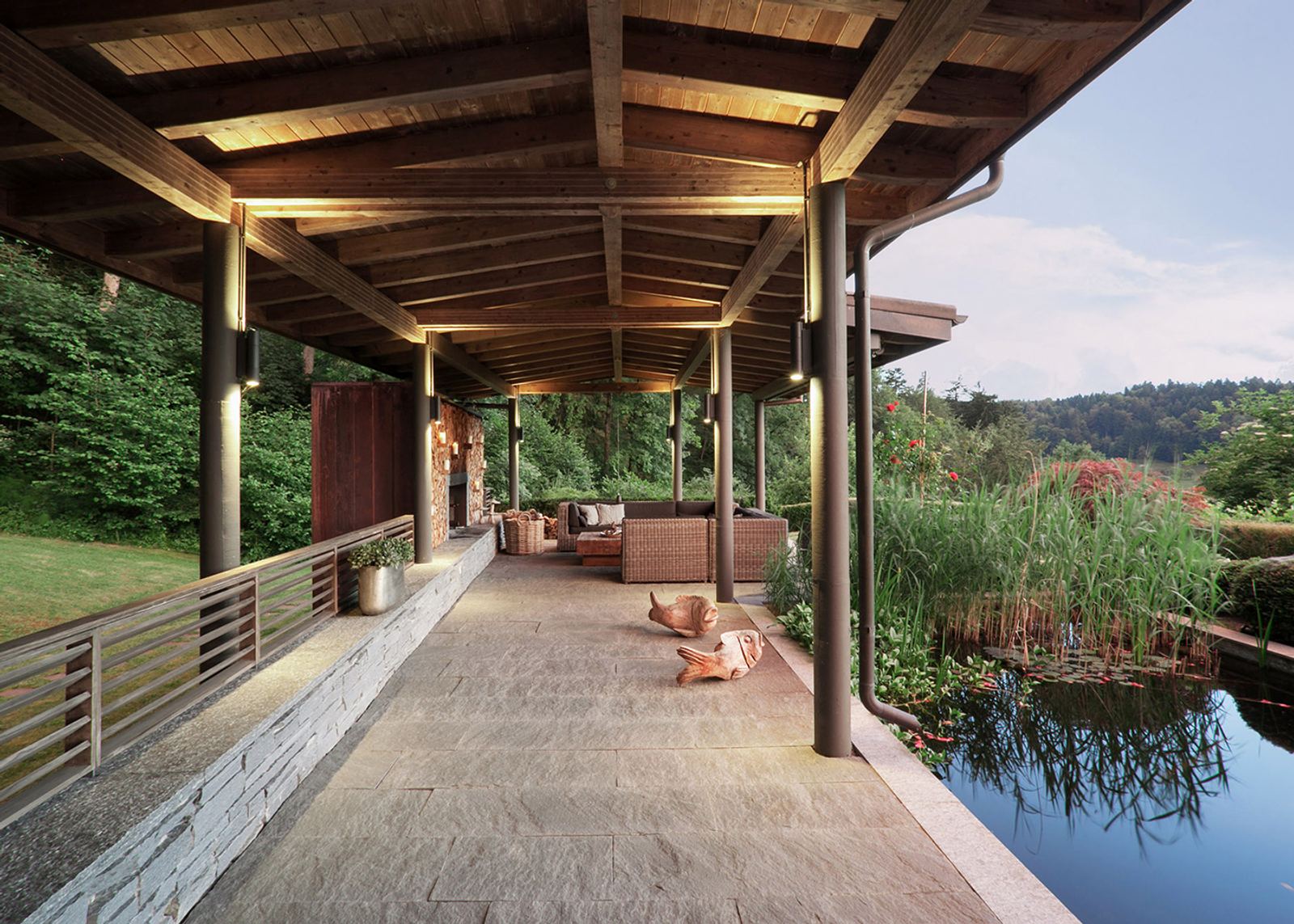 Timber-roofed veranda along the pond