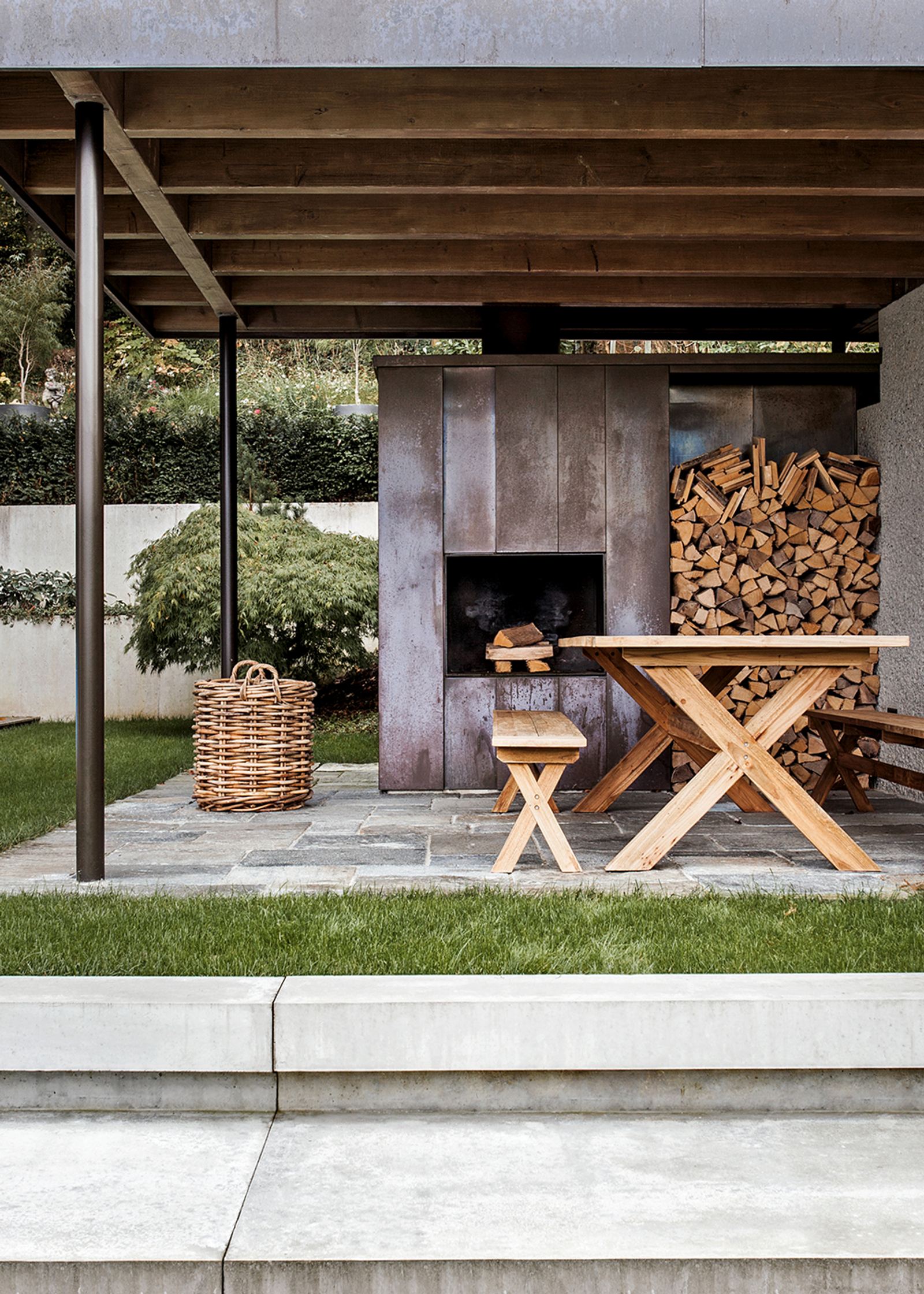 Covered seating area with fireplace and timber table