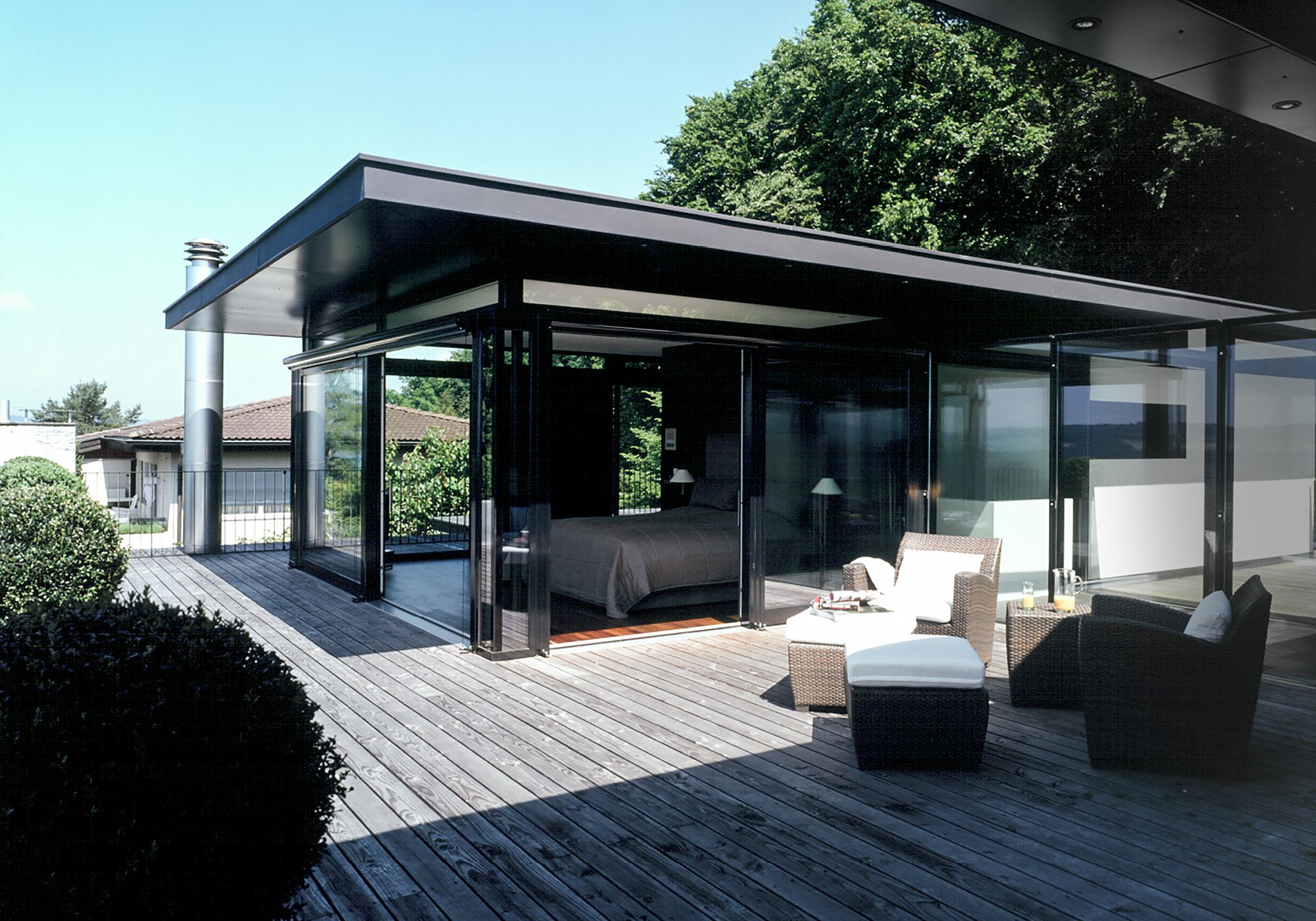 Timber terrace with lounge furniture under the roof – Single-family house in Uitikon