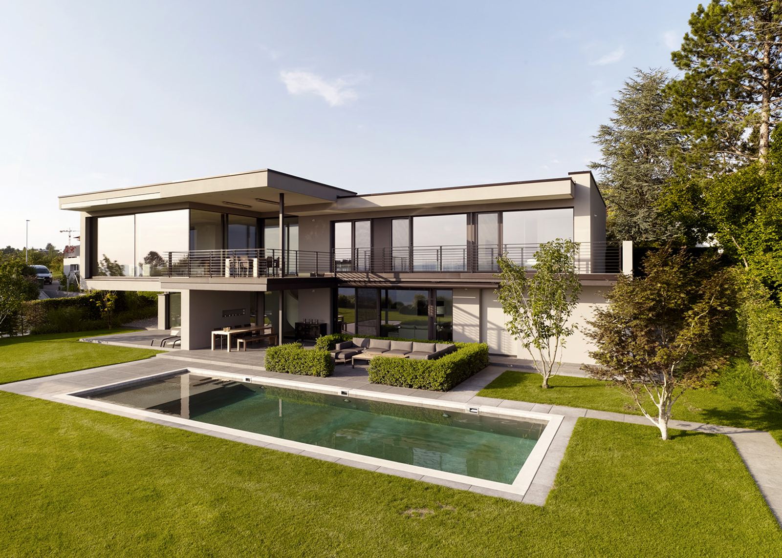 Rectangular pool in the lawn in front of the house