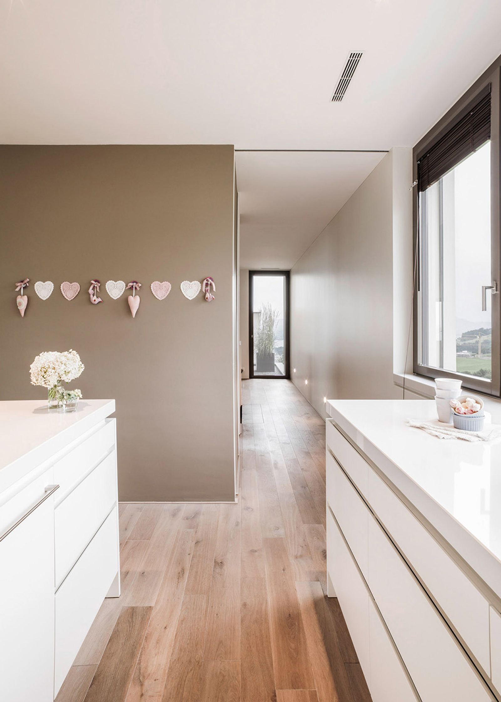 White kitchen runs with timber floor