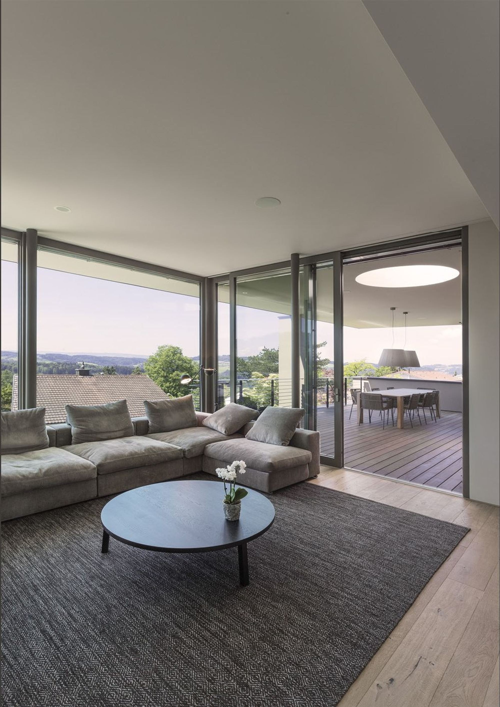 Living corner with sofa and view of the terrace – Single-family house in Uitikon