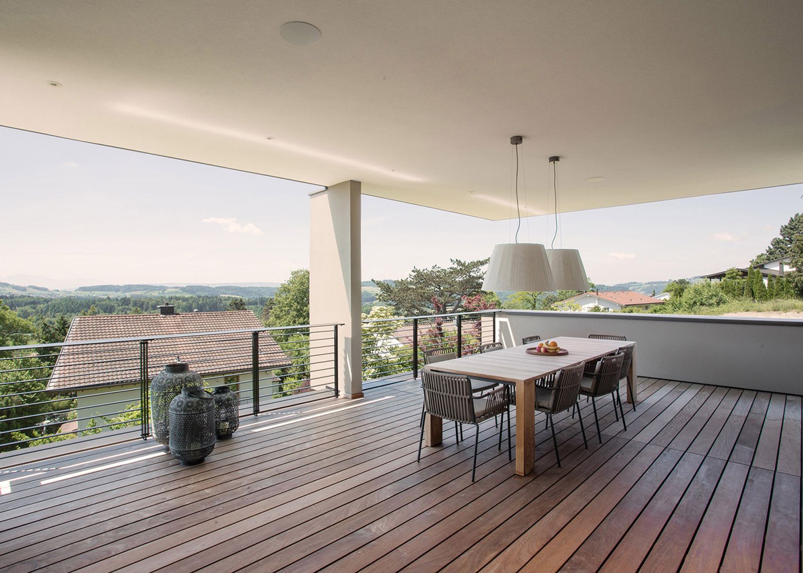 Terrace with dining table and pendant lights