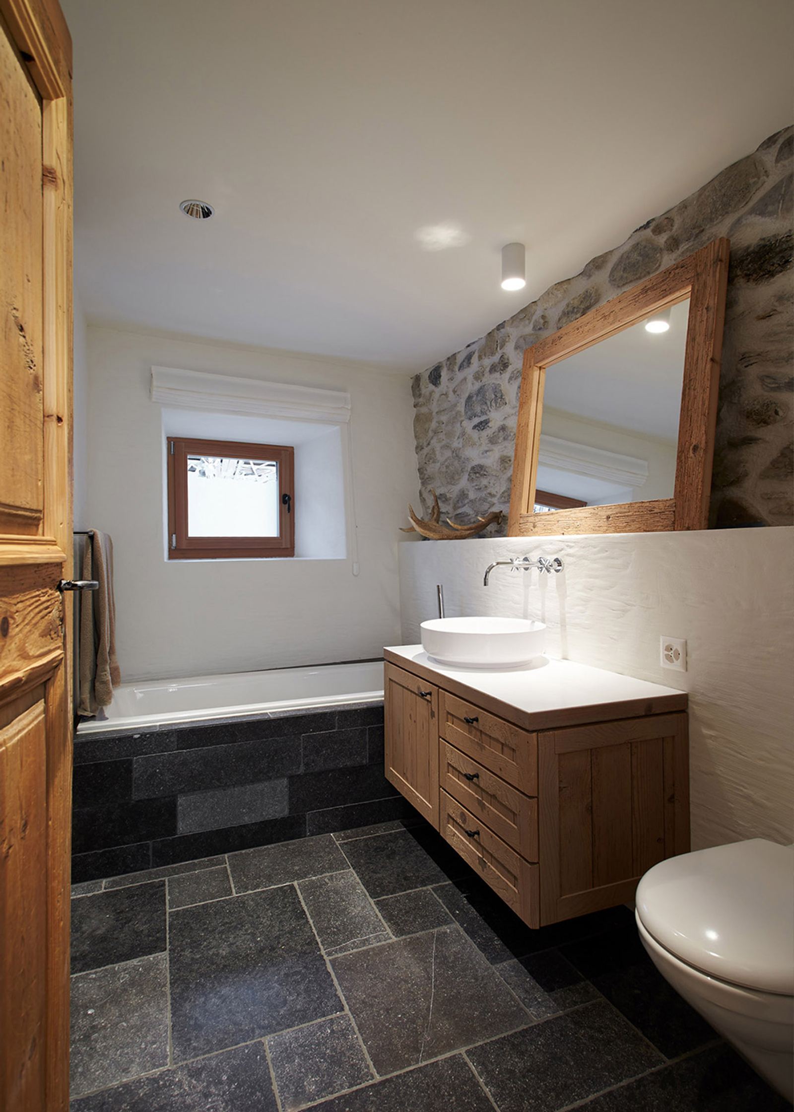 Bathroom with slate floor and timber mirror