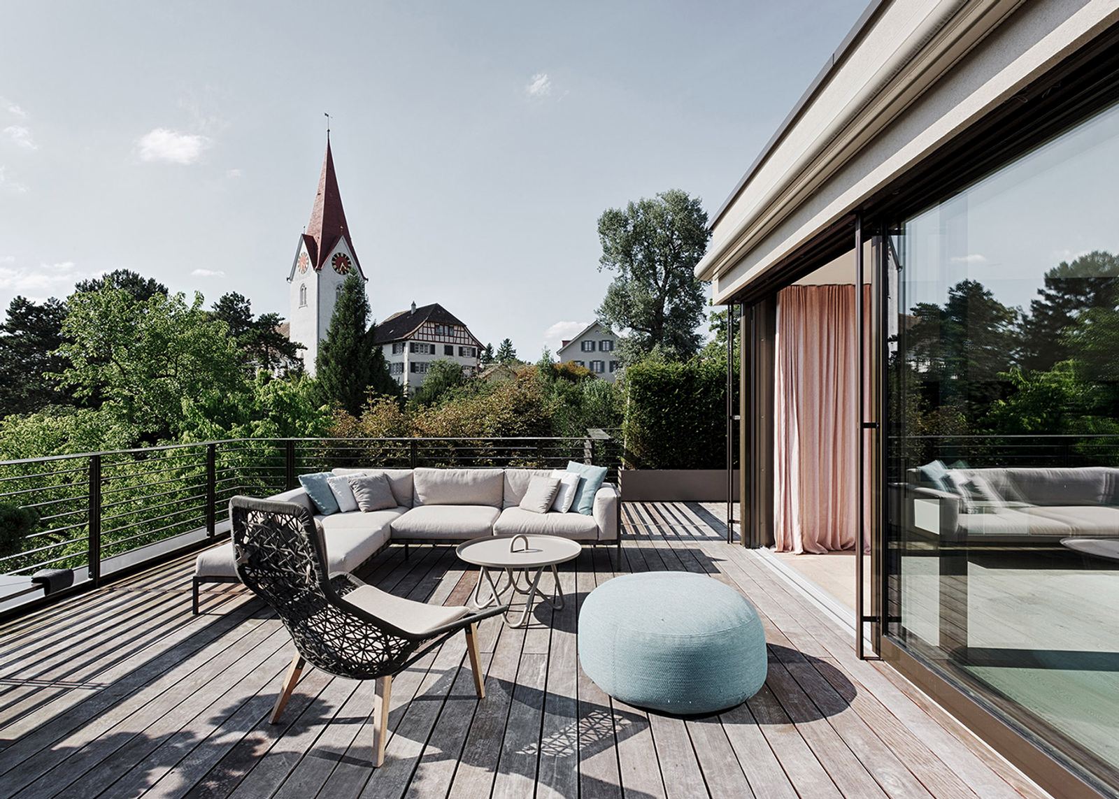 Terrace with lounge furniture and church tower