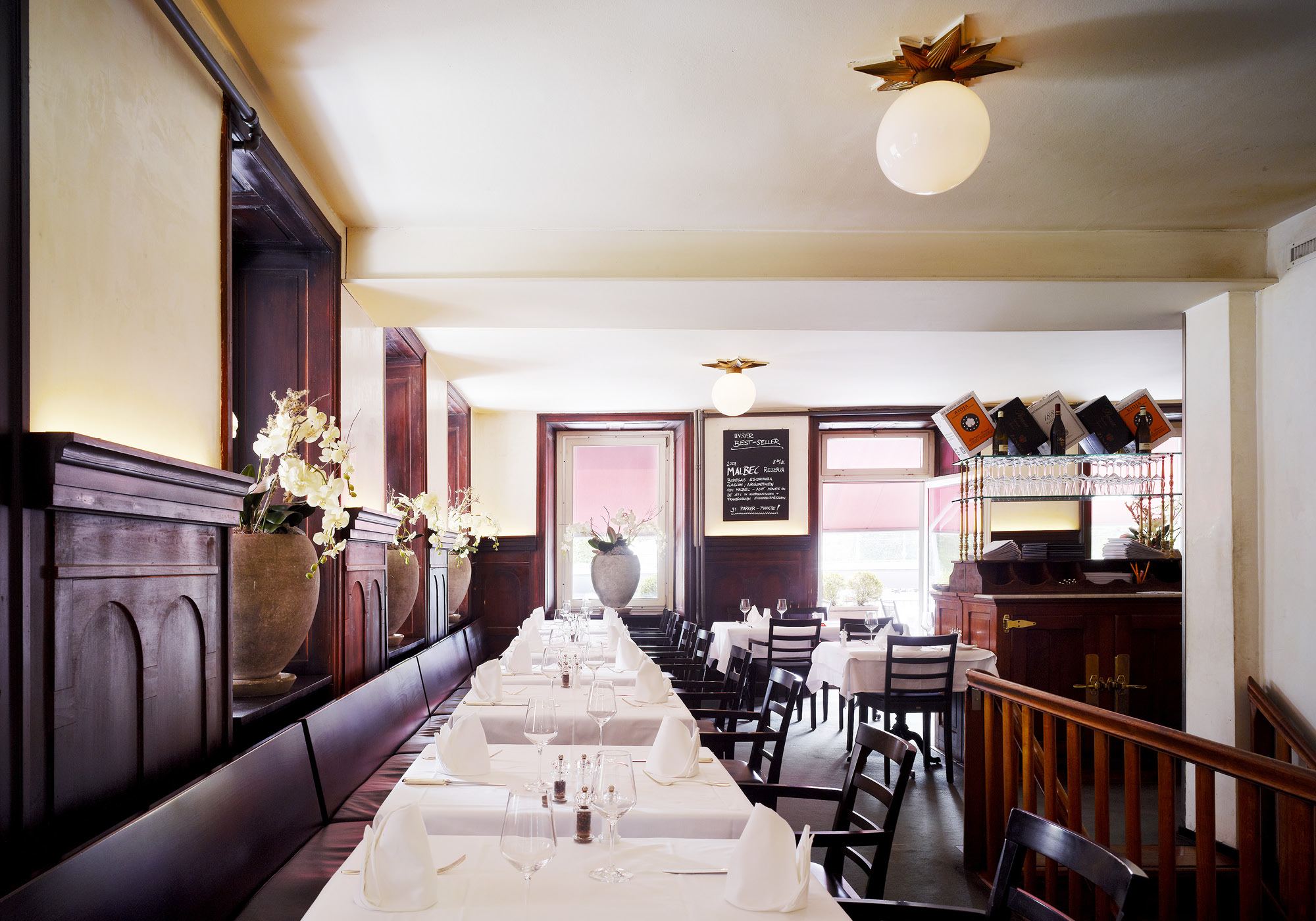 Dining room with timber panelling and globe light – Interiors and landscape, Zürich