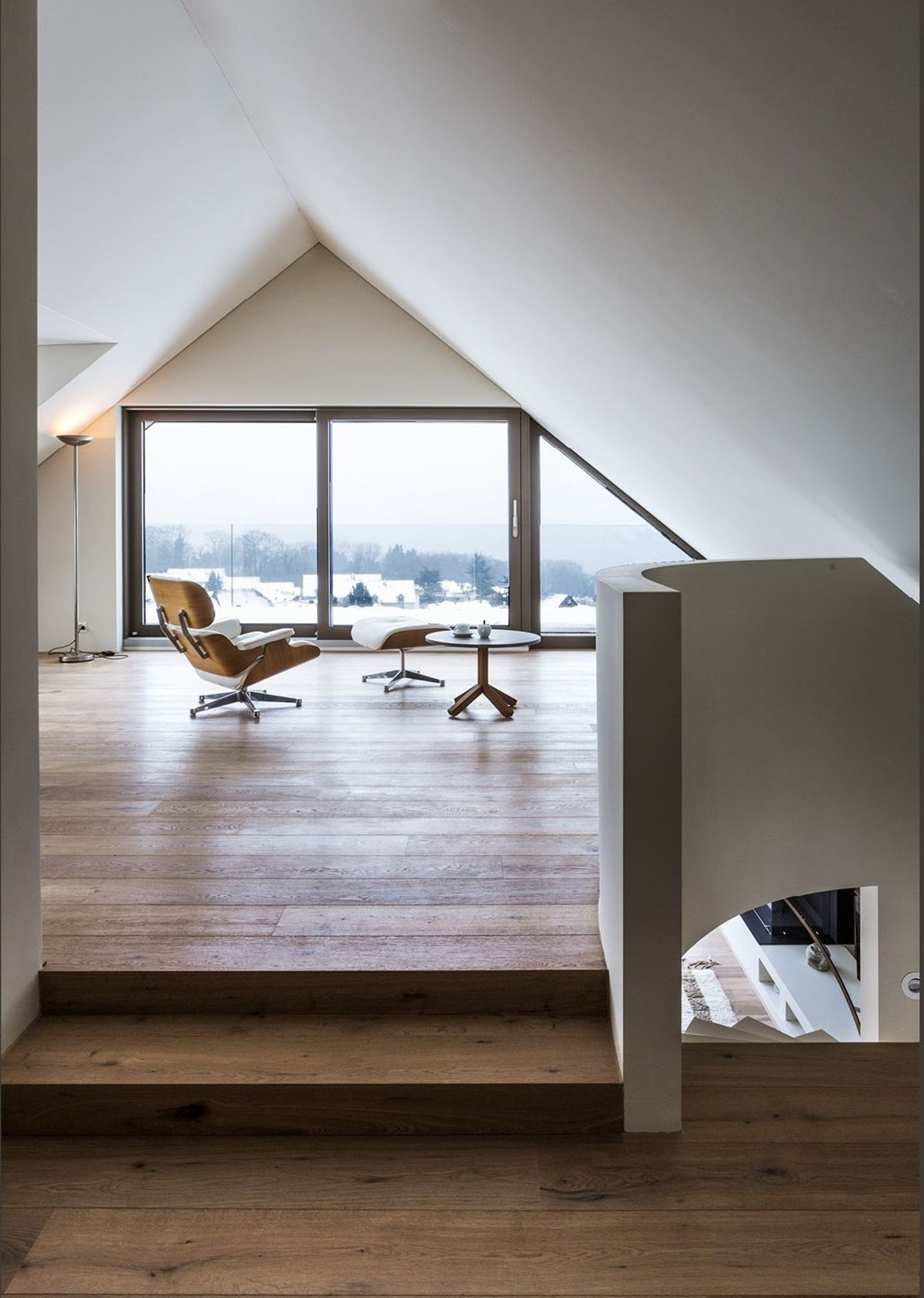 Attic room with gable window and lounge chair – Interiors and landscape, Herrliberg