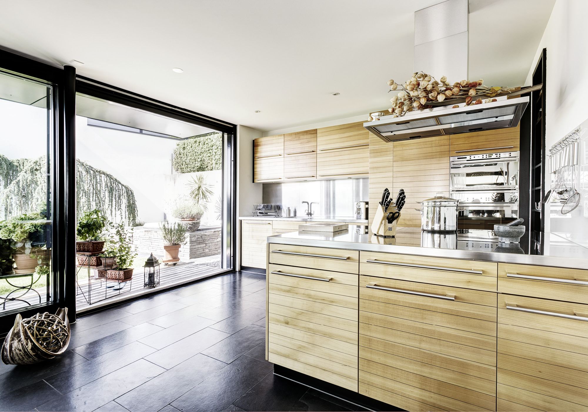 Kitchen with timber fronts and view of the terrace – Single-family house in Uitikon