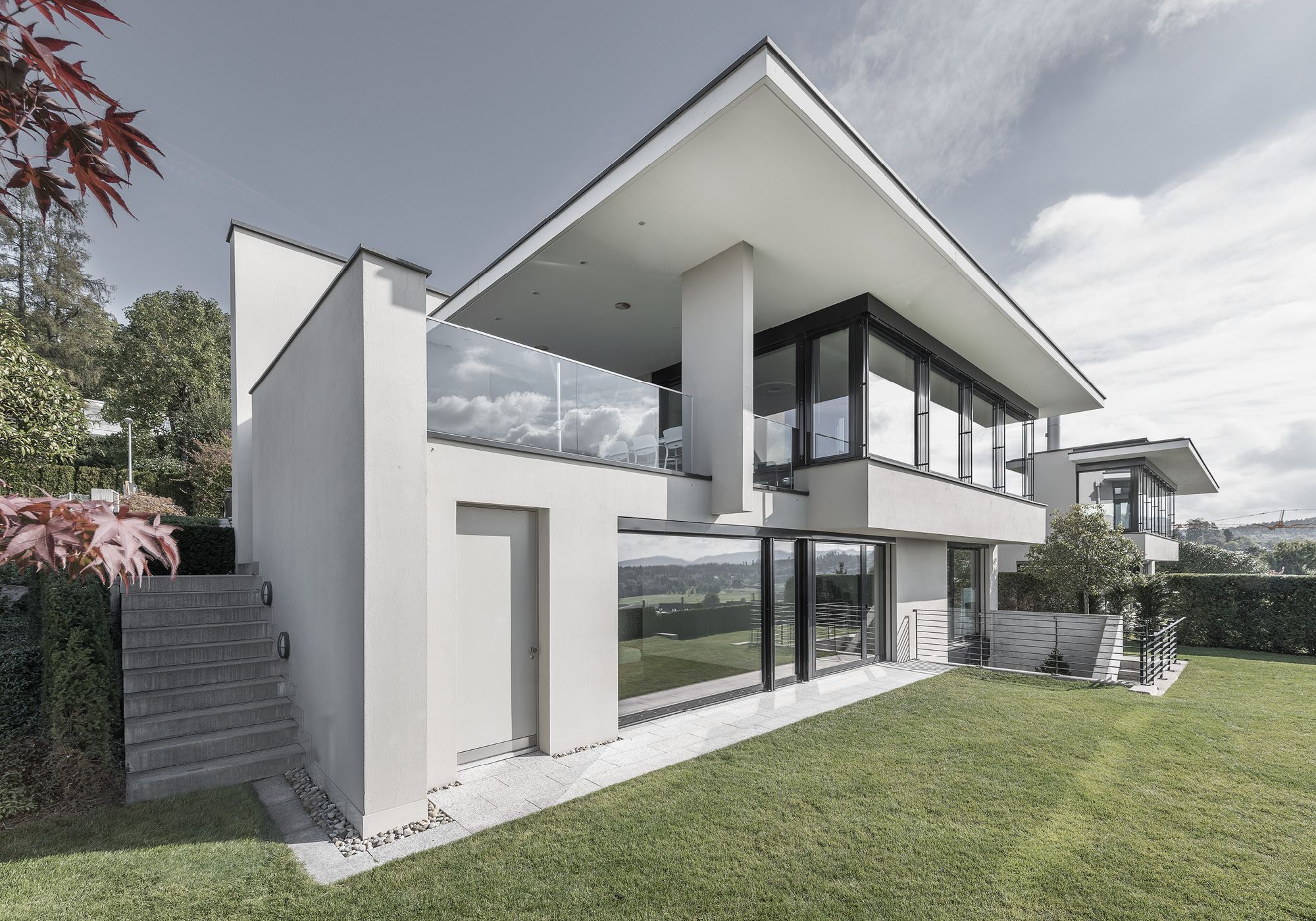 Corner of the house with outside stair and glass balustrade – Single-family house in Uitikon