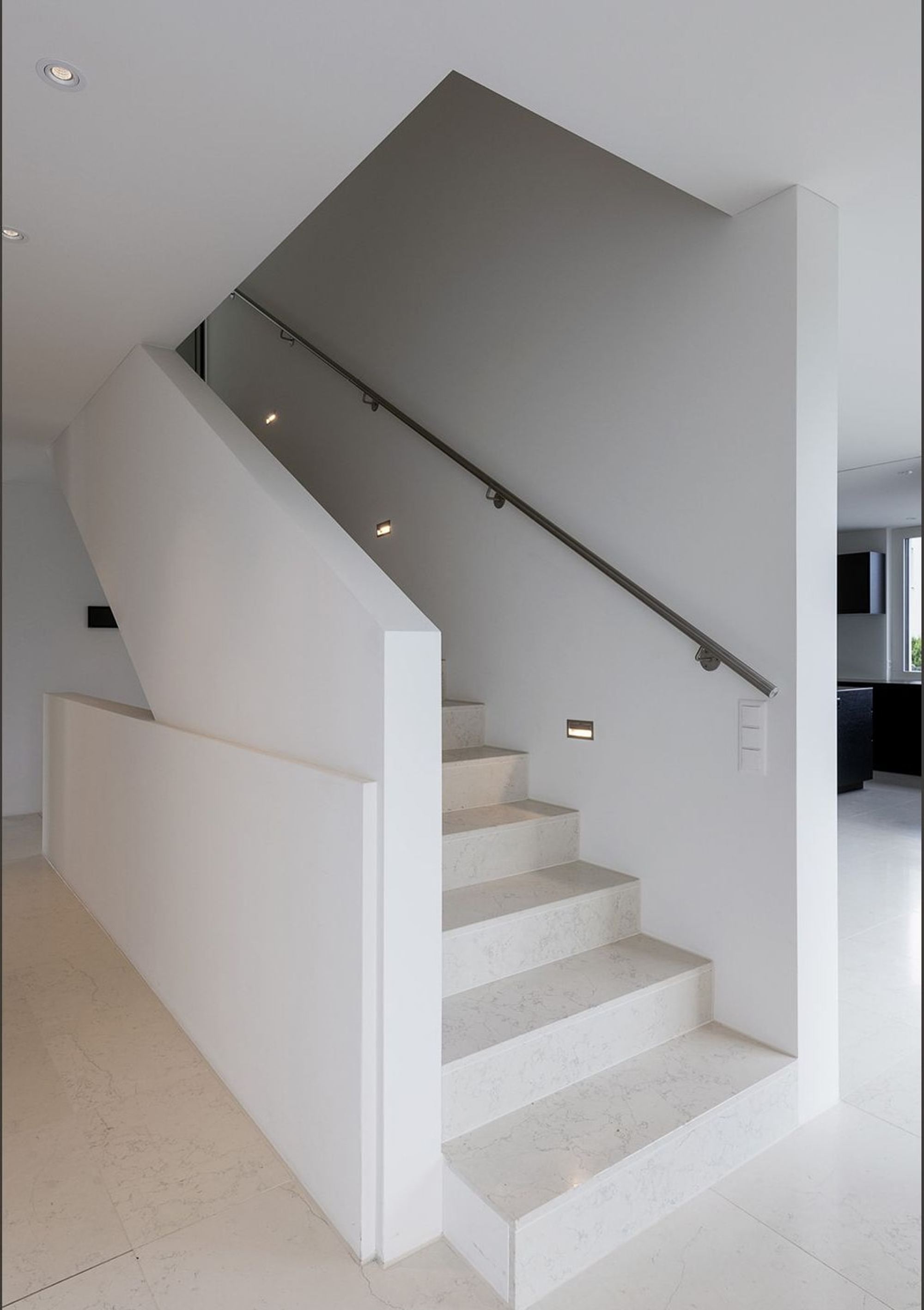 White staircase with handrail and wall lights – Single-family house in Zürich