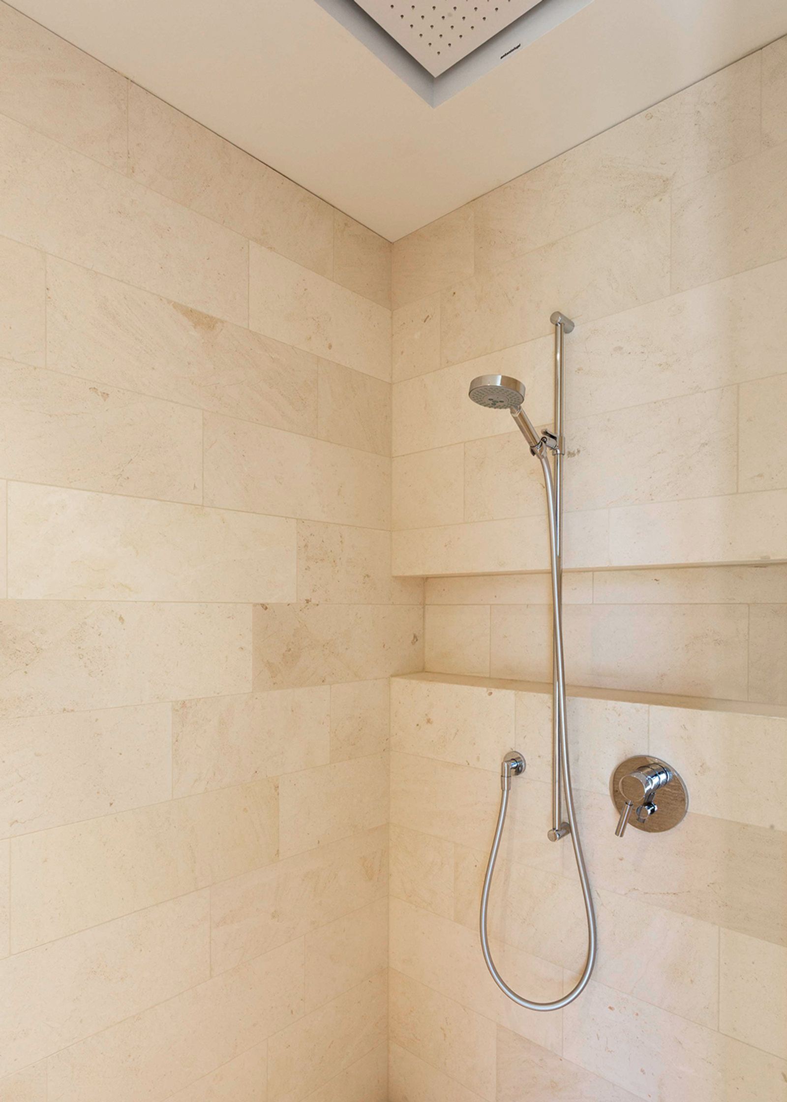 Shower with light natural stone slabs