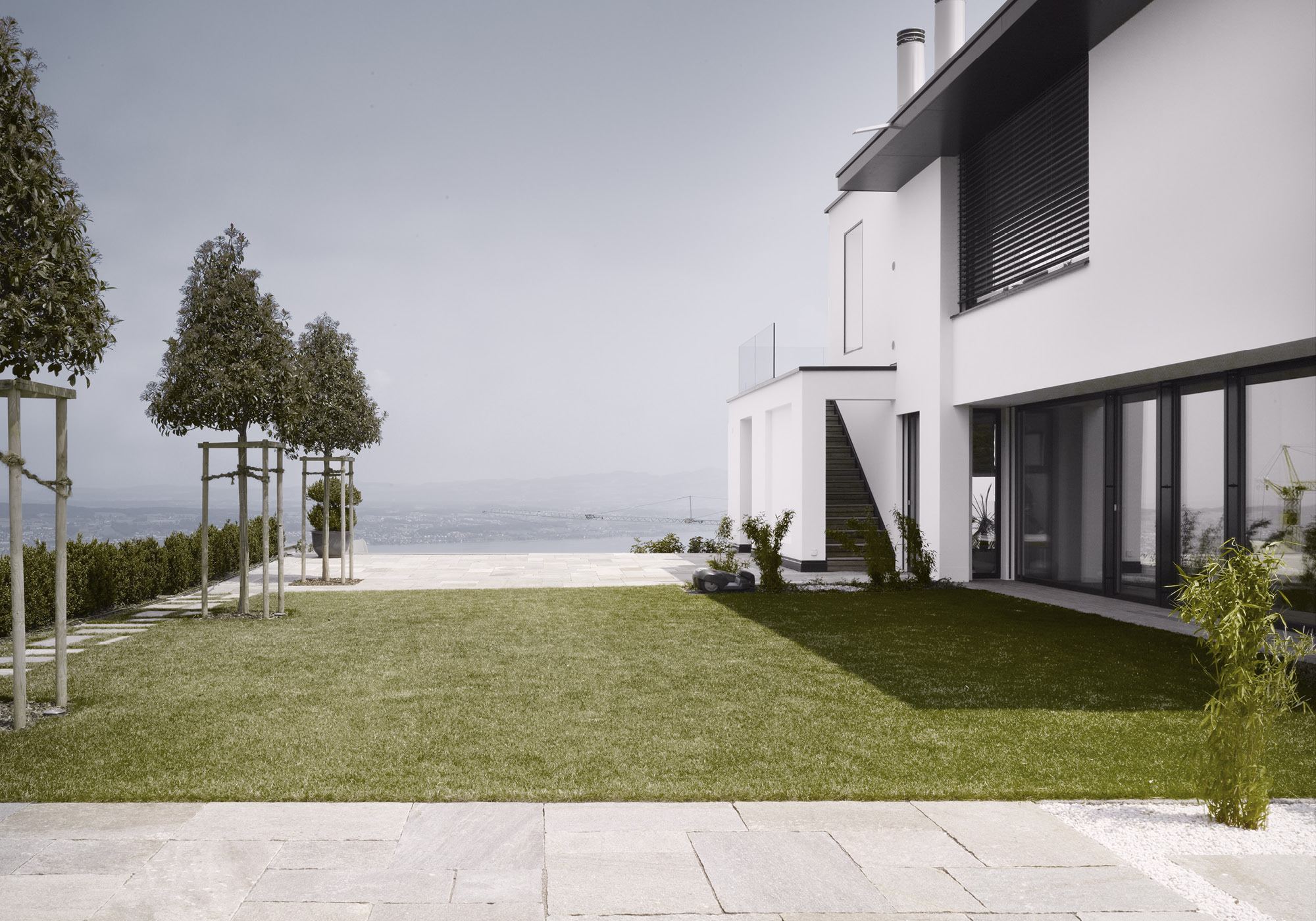 Lawn with a row of trees and view to the lake – Single-family house in Schindellegi