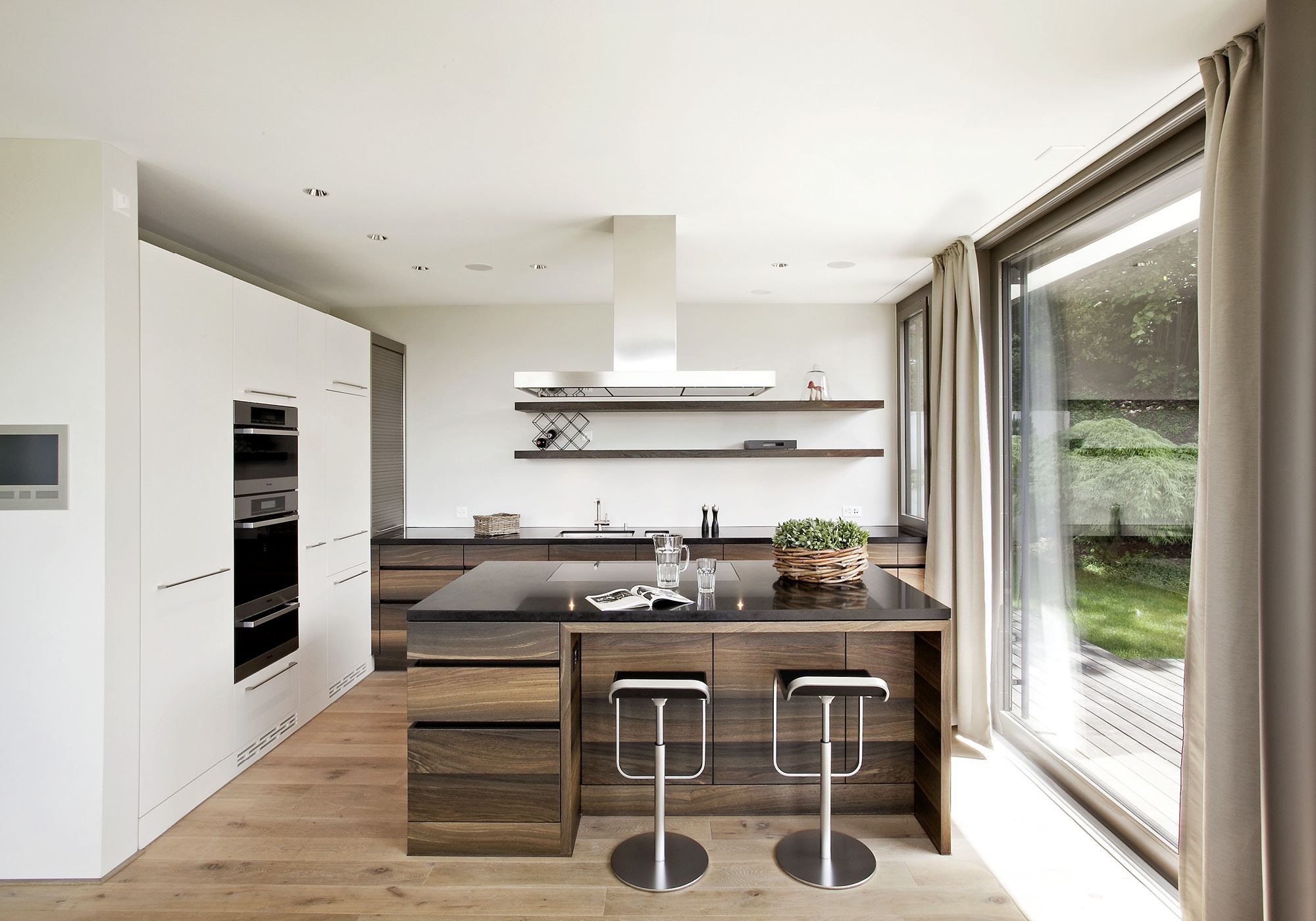 Kitchen with timber island and bar stools – Apartment building in Uitikon