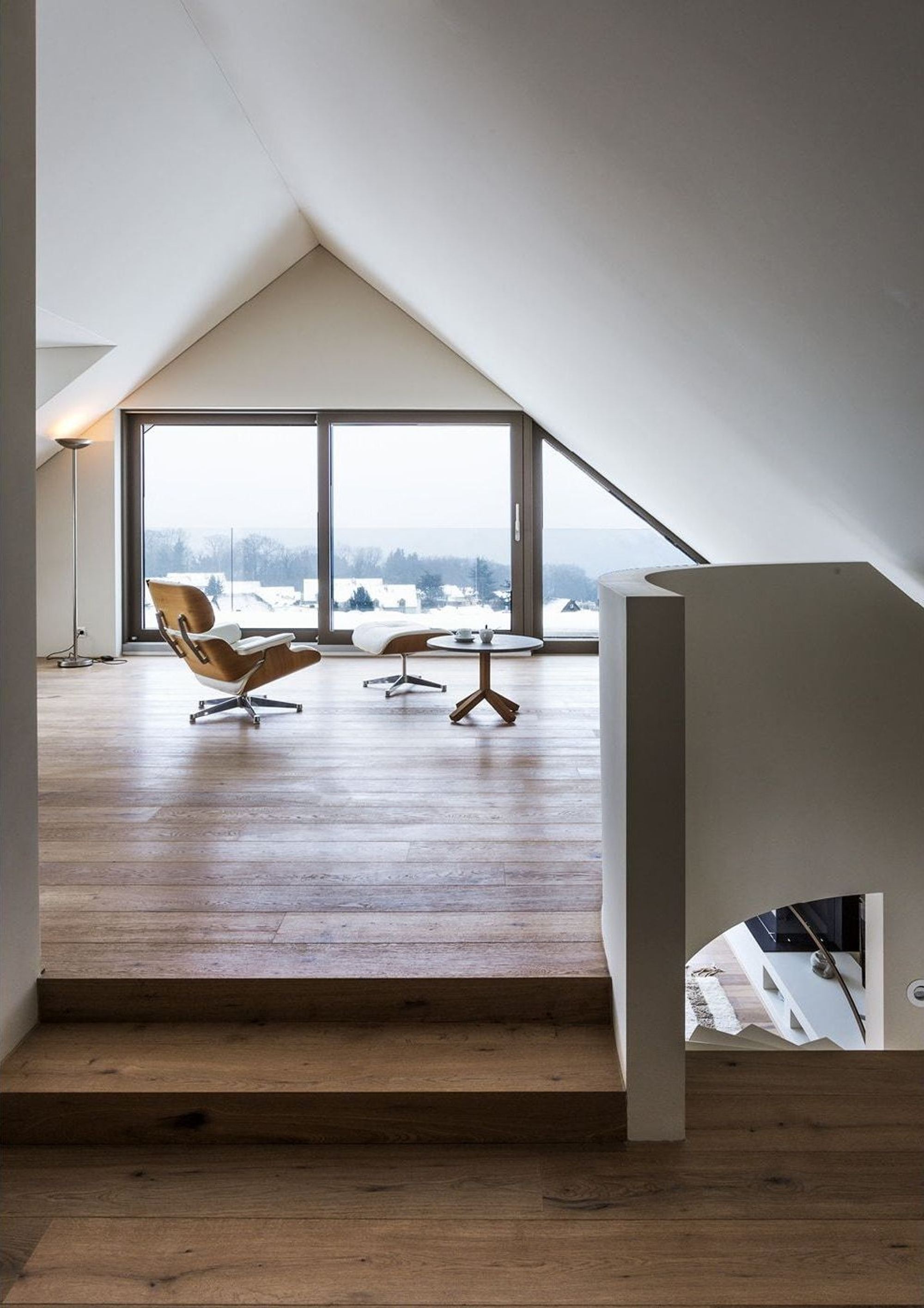 Attic room with gable window and lounge chair – Interiors and landscape, Herrliberg