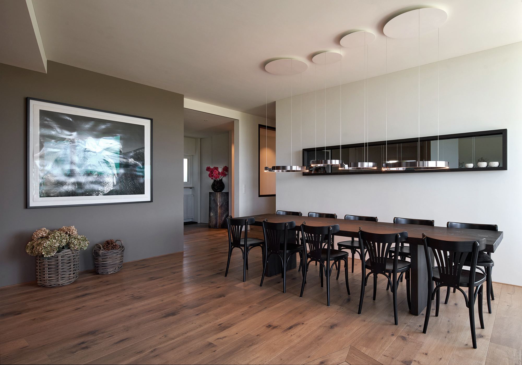 Dining area with long table and wall niche – Interiors and landscape, Lufingen