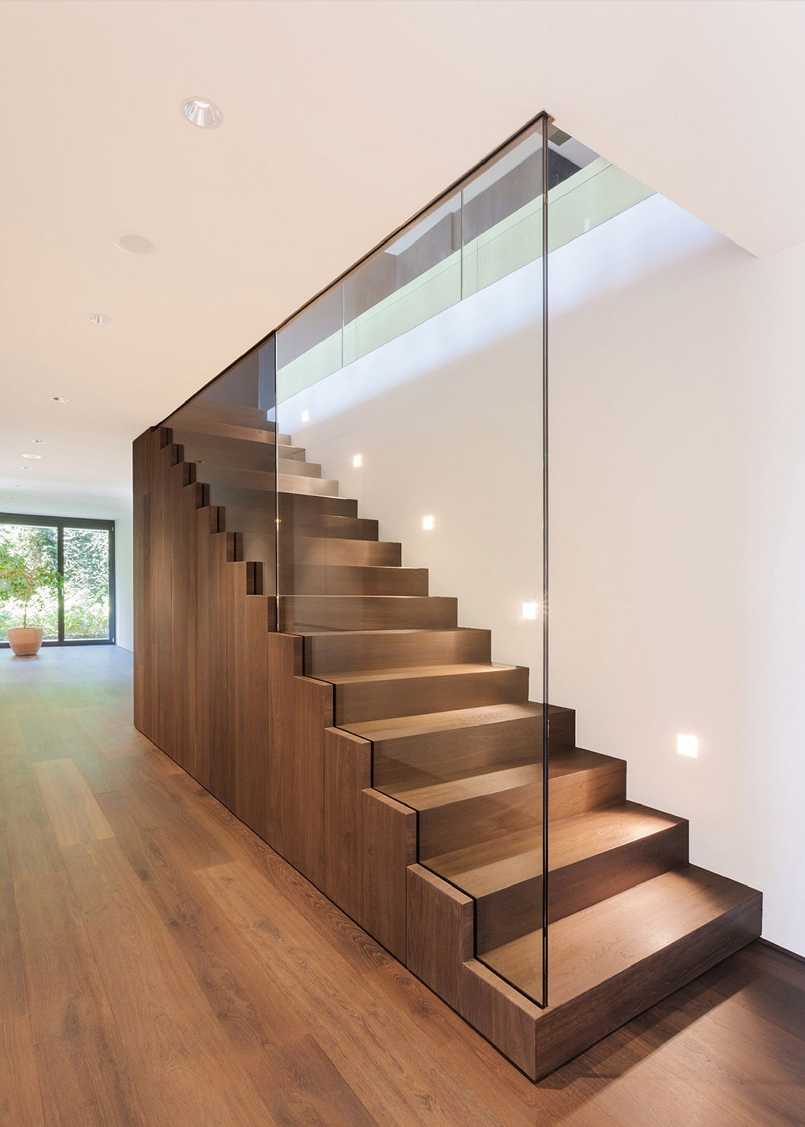 Timber staircase with glass balustrade and step lights