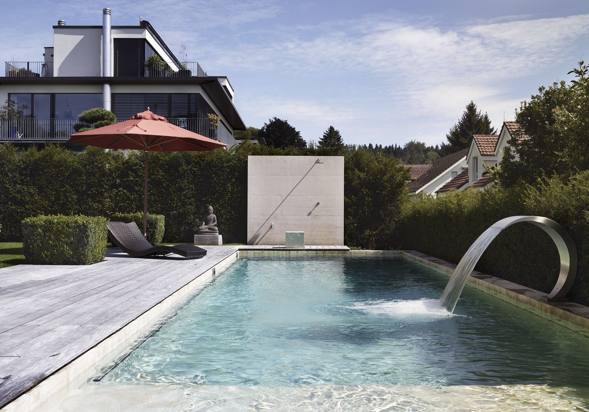 Pool with stainless steel water spout and timber deck – Interiors and landscape, Uitikon