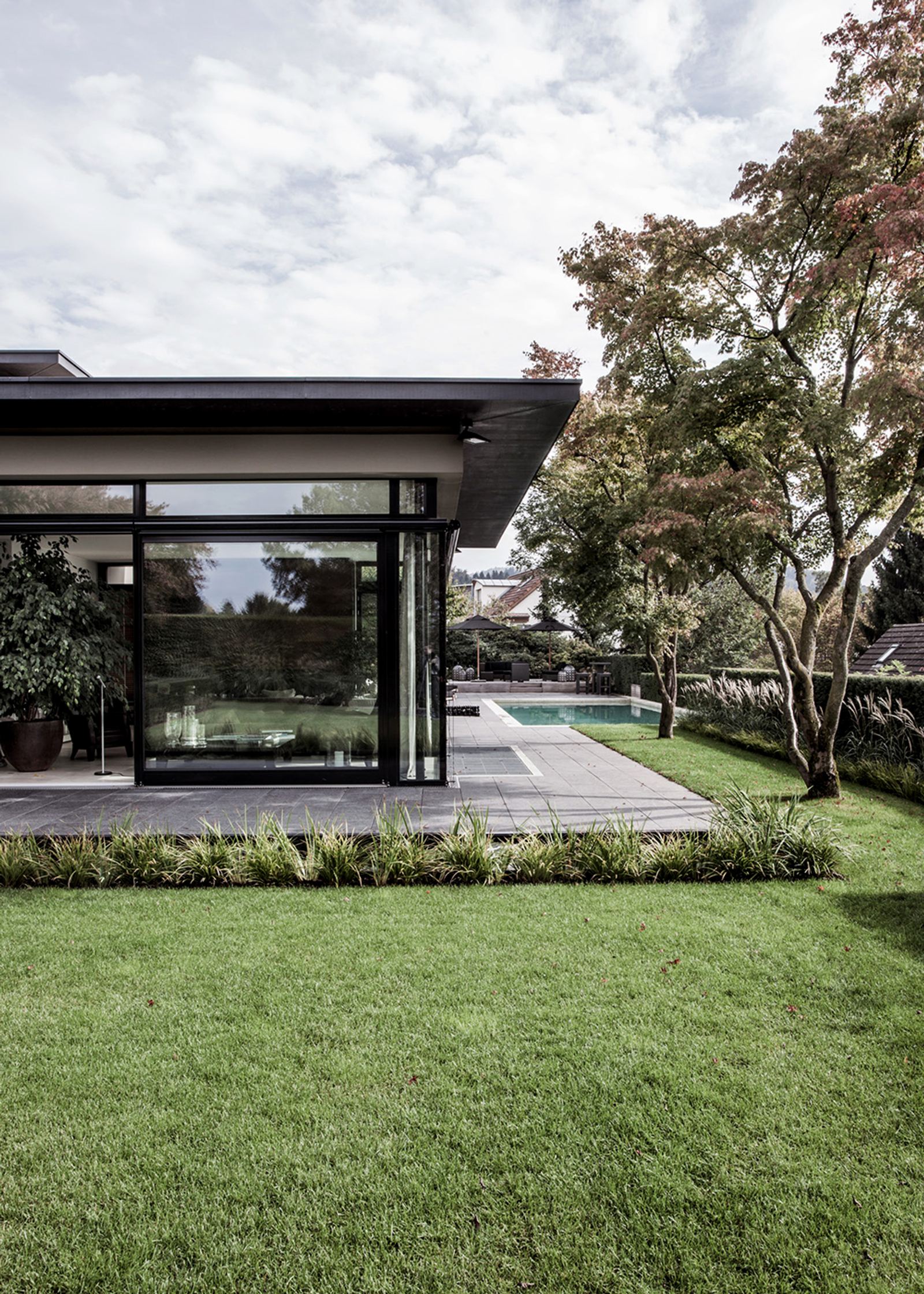 Glass pavilion beyond the lawn
