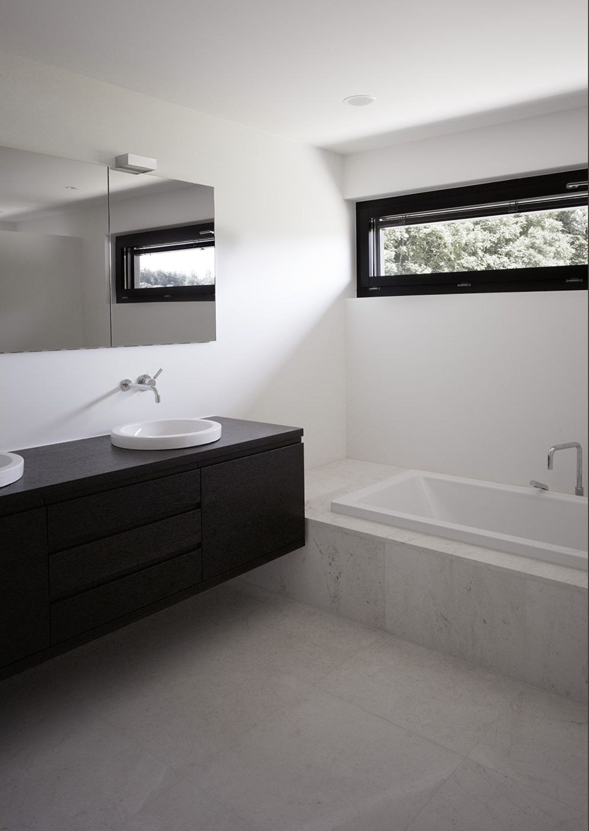 Bathroom with dark vanity and ribbon window – Single-family house in Mülligen