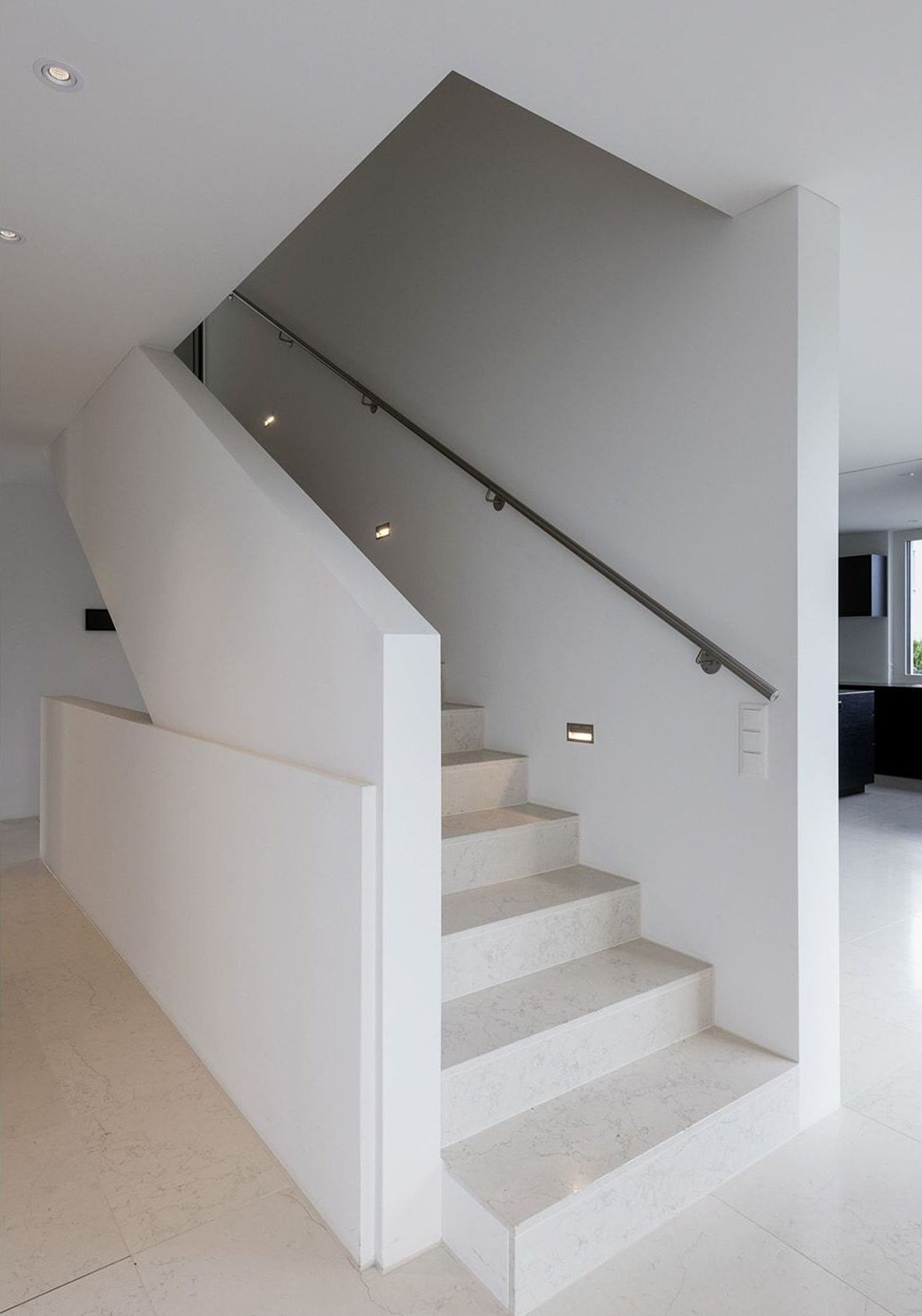 White staircase with handrail and wall lights – Single-family house in Zürich