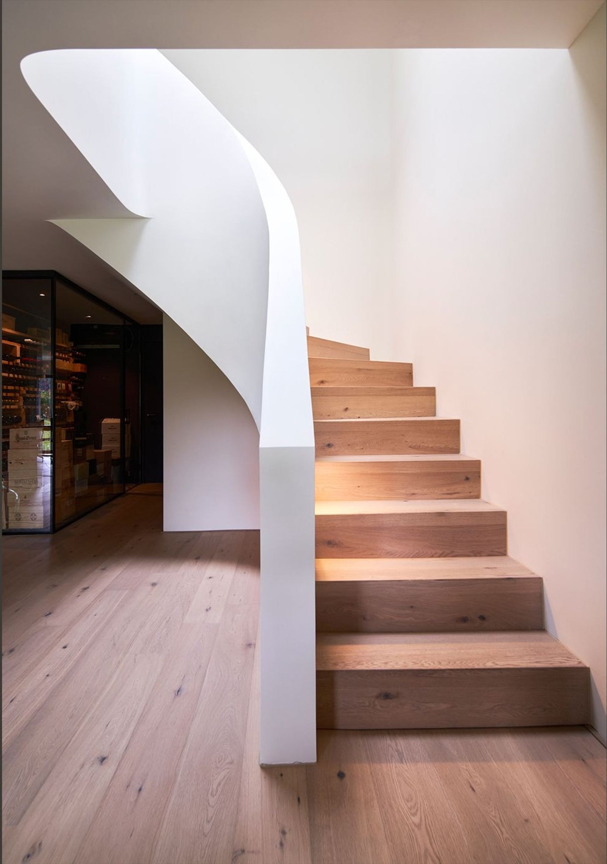 Curved staircase with timber treads and white stringer – Interiors and landscape, Wettswil
