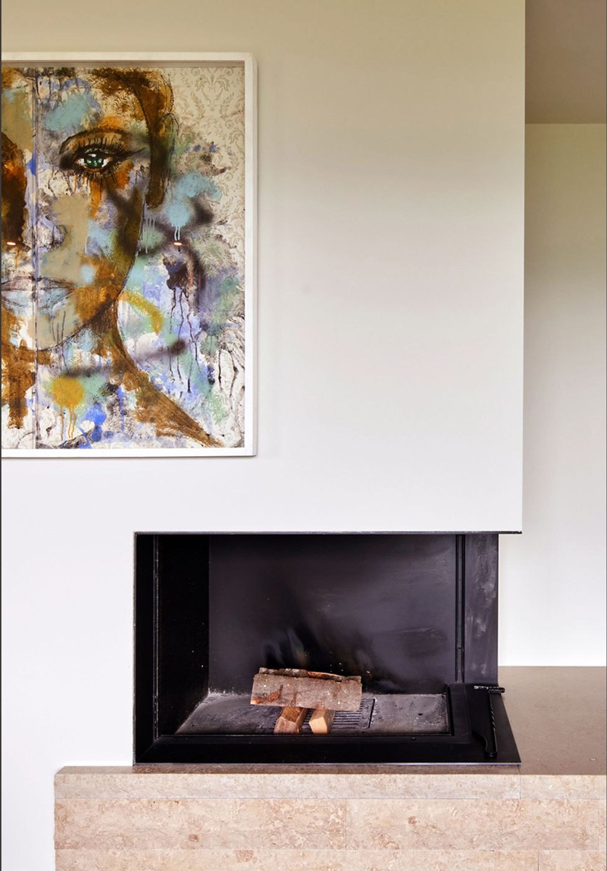 Fireplace with natural stone base and artwork – Interiors and landscape, Meilen