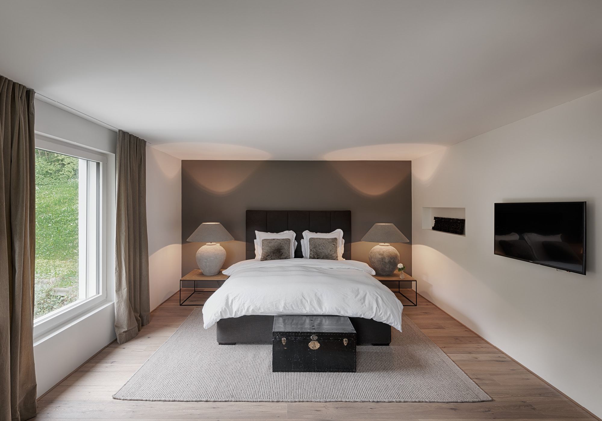 Bedroom with double bed and timber floor – Interiors and landscape, Stallikon