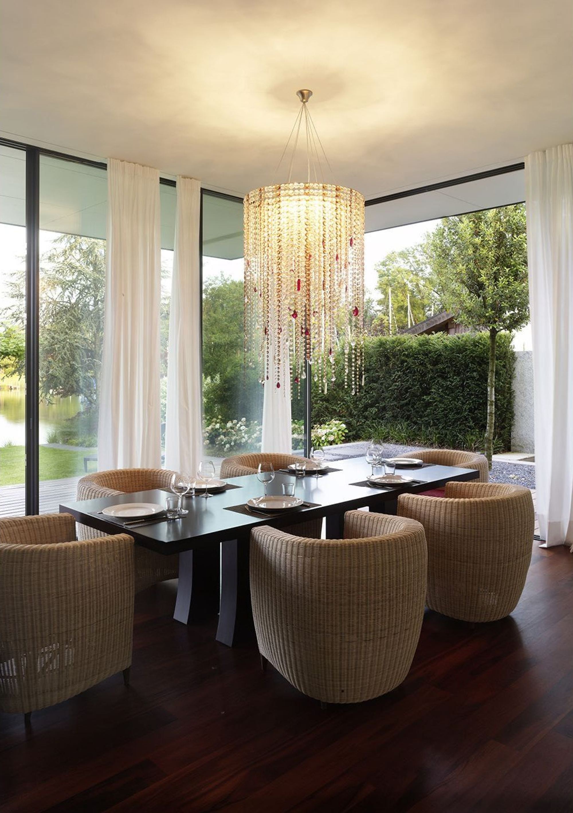 Dining table with armchairs beneath the crystal chandelier – Single-family house in Lachen