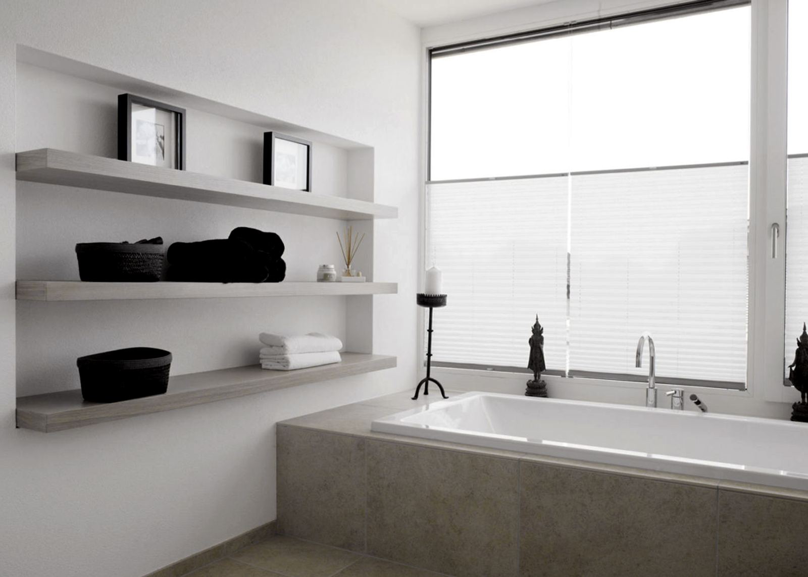 Bathtub with wall shelves by the window