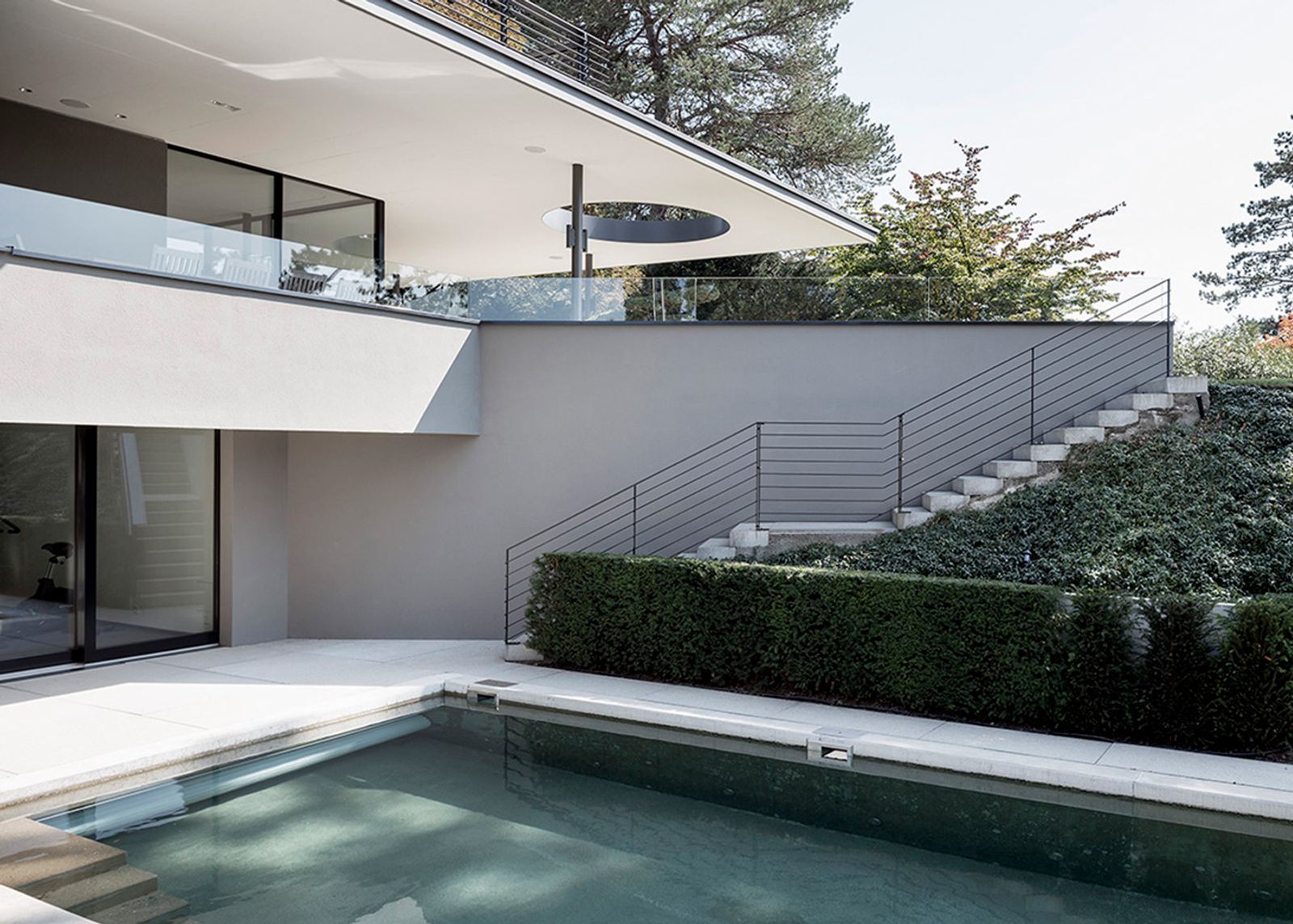 Pool in front of the hillside facade with steps