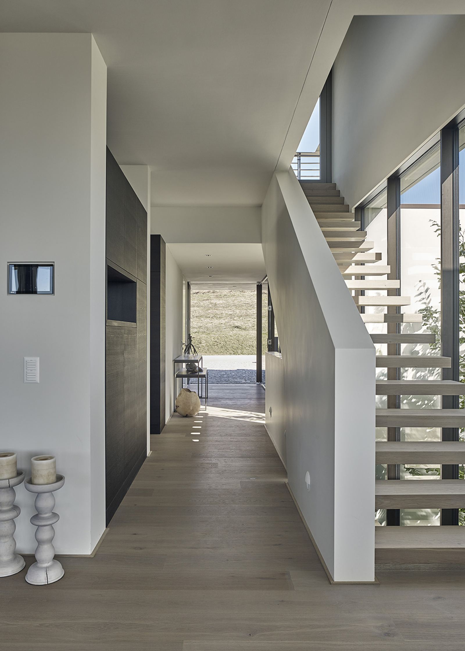 Hallway with open staircase and timber floor