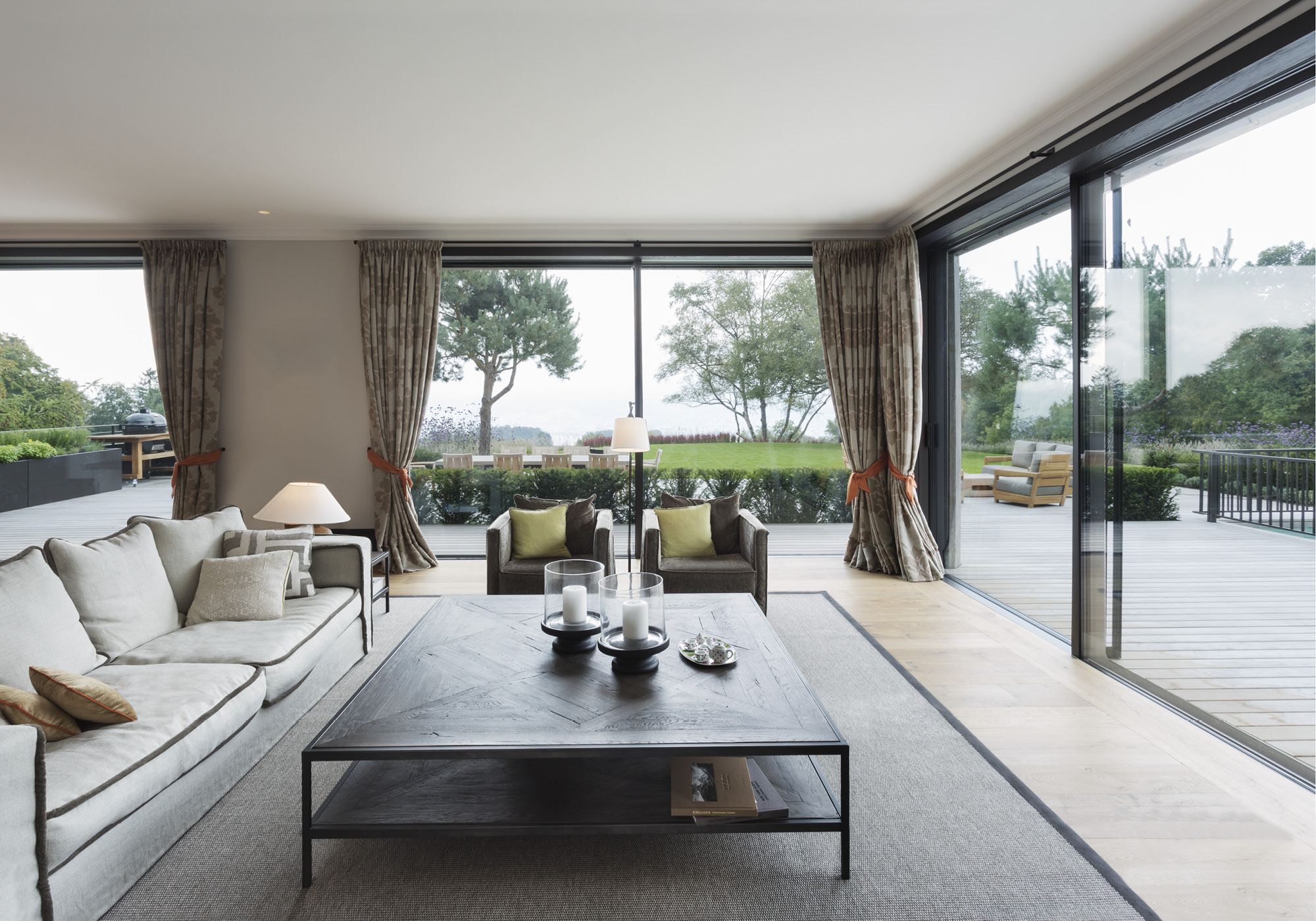 Living room with sofas and window front to the garden – Single-family house in Herrliberg