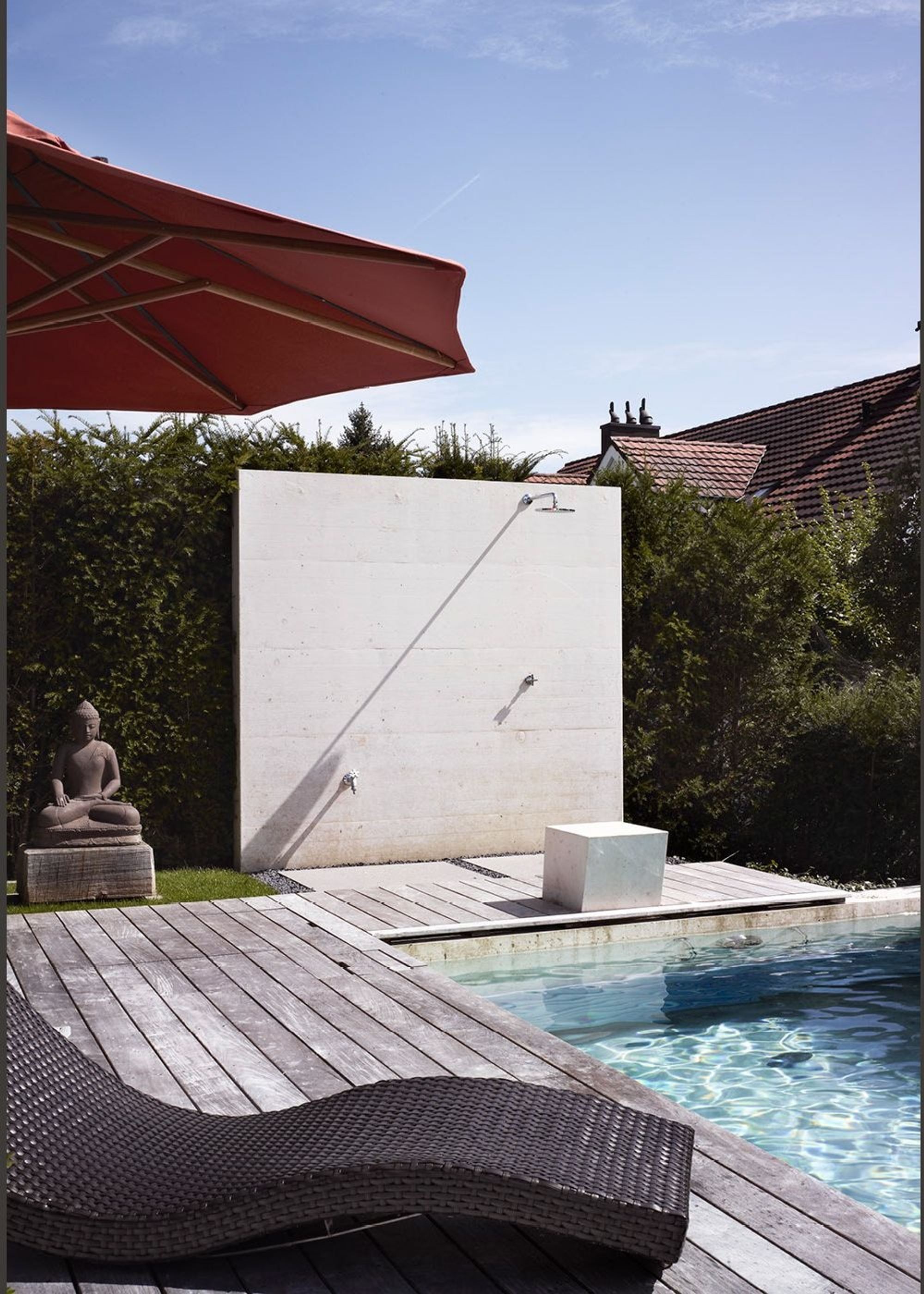 Timber deck with lounger and Buddha figure by the pool – Interiors and landscape, Uitikon