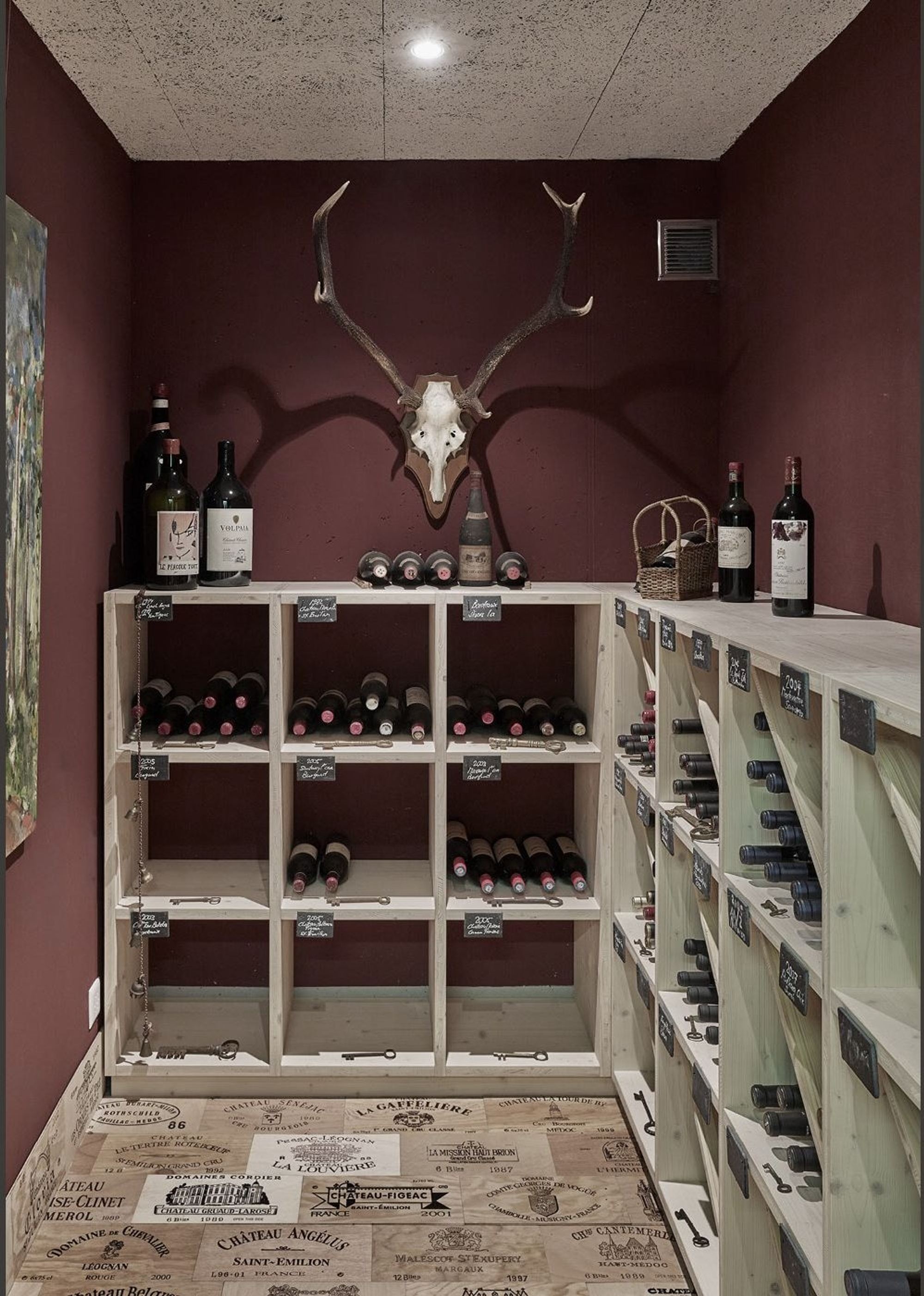 Wine cellar with shelving and antlers – Apartment building in Uitikon
