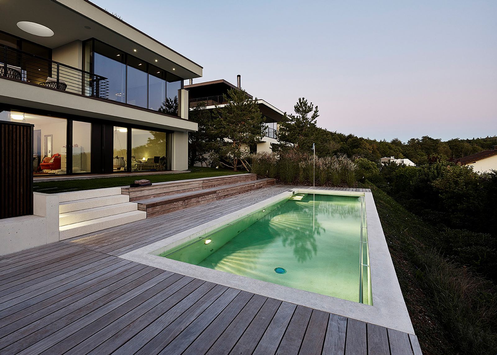 Pool with timber deck at dusk