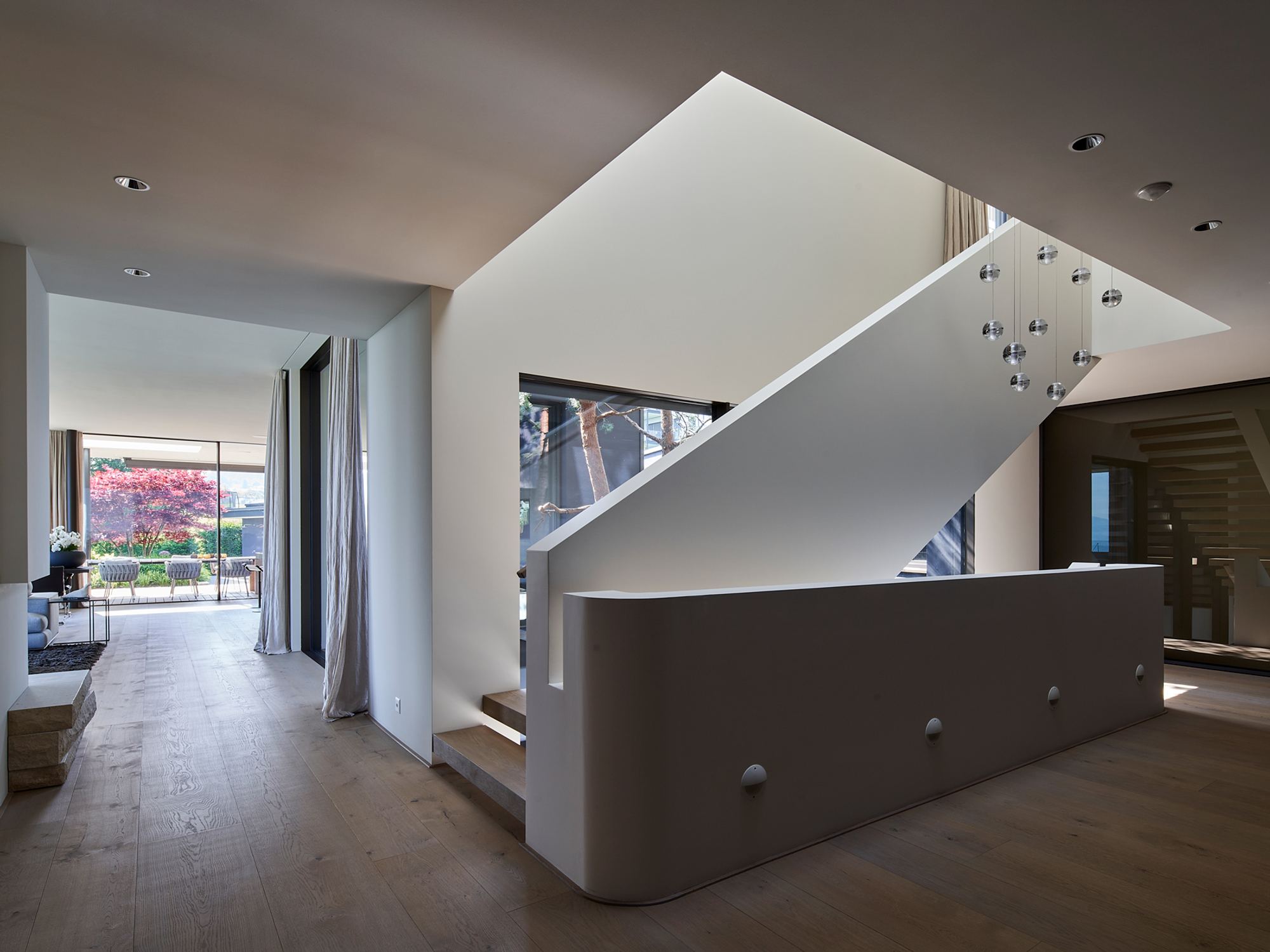 White staircase with solid balustrade and skylight – Single-family house in Schindellegi