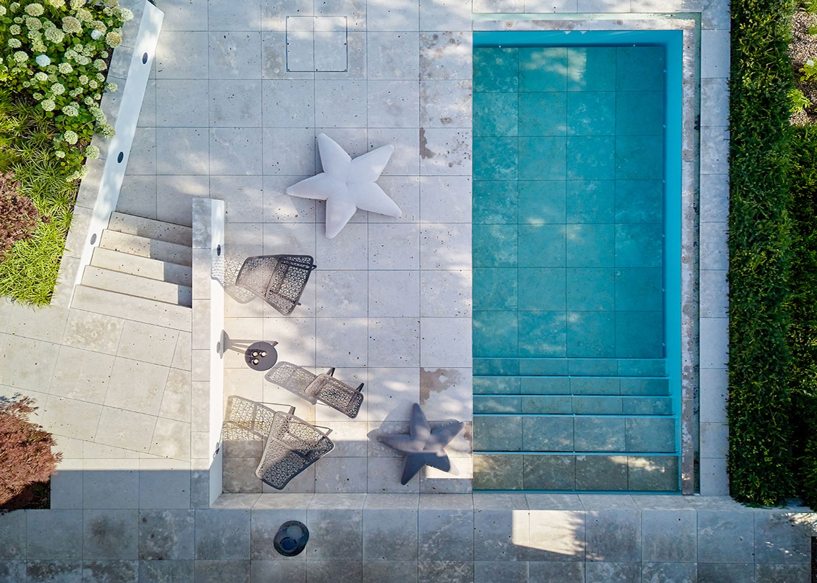 Pool from above with star-shaped cushions