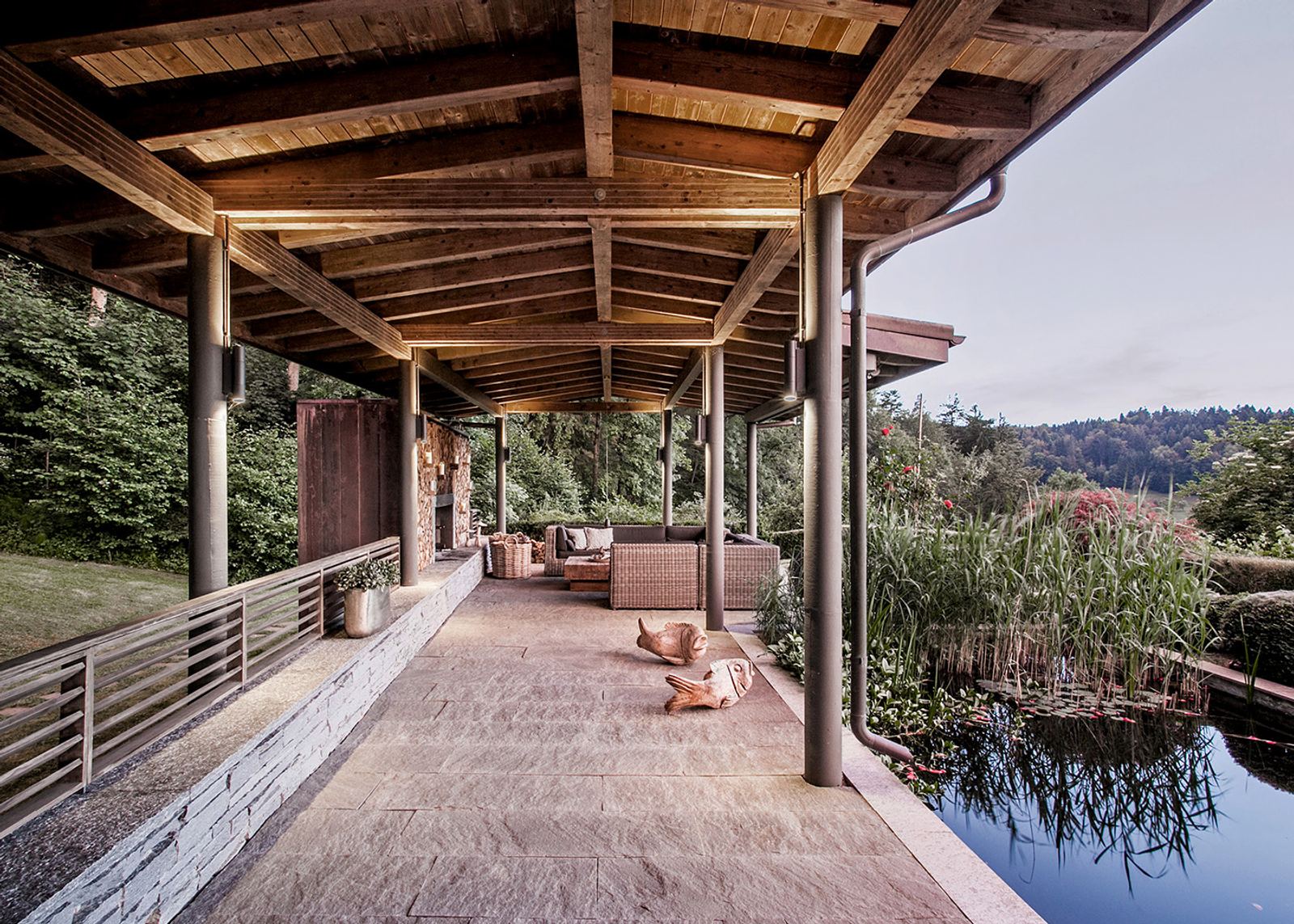 Timber-roofed veranda along the pond