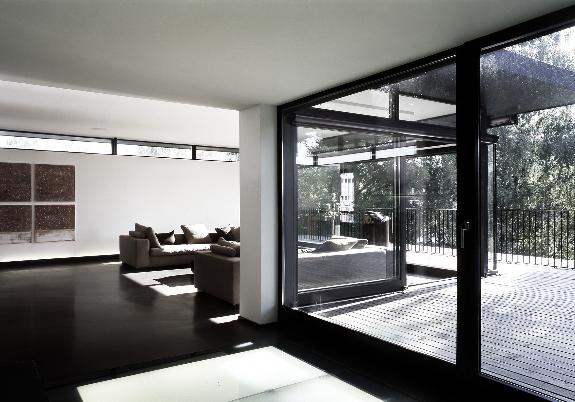Living room with sofa and glass front to the terrace – Single-family house in Dietikon
